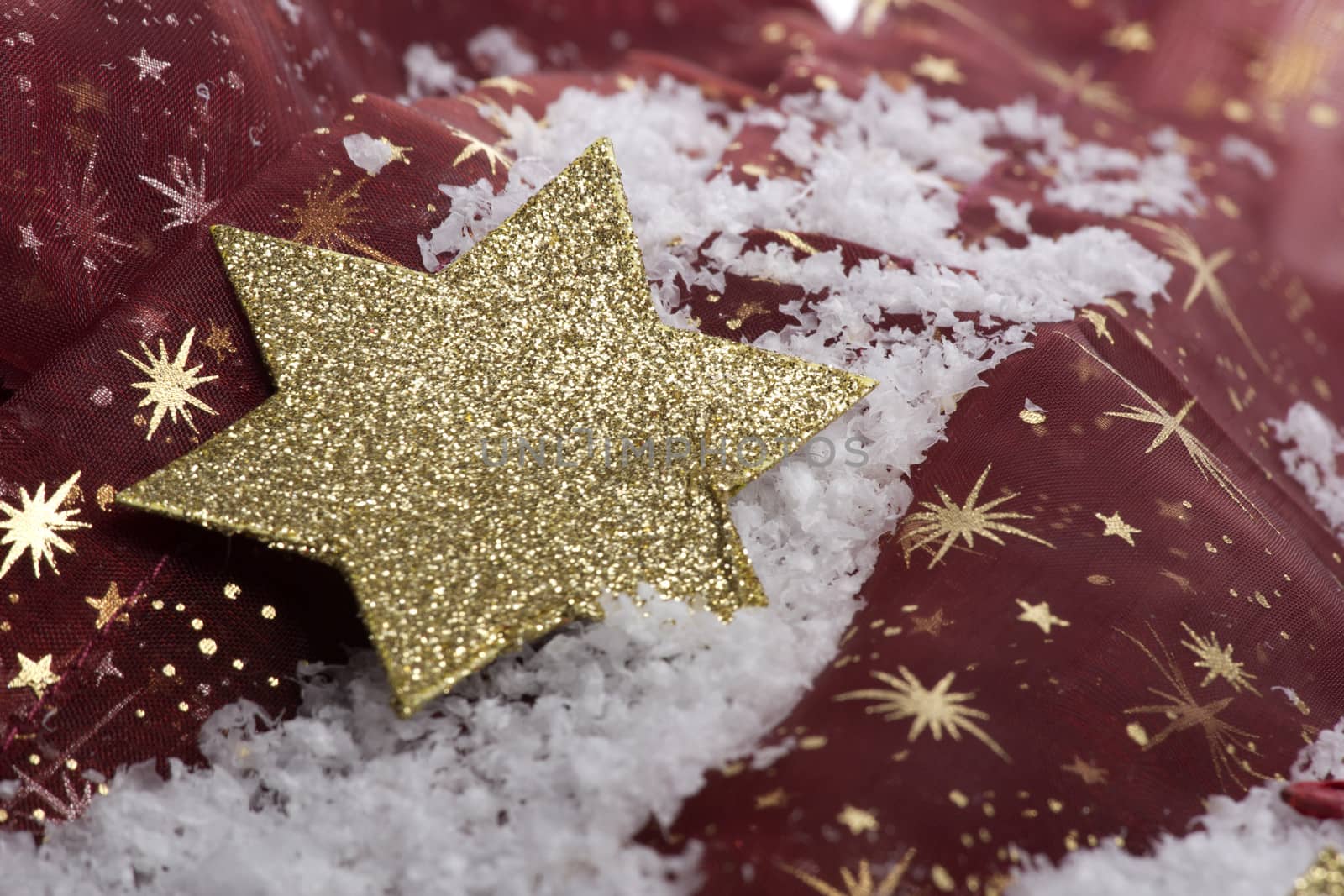 christmas, golden christmas star on snow with decoration 