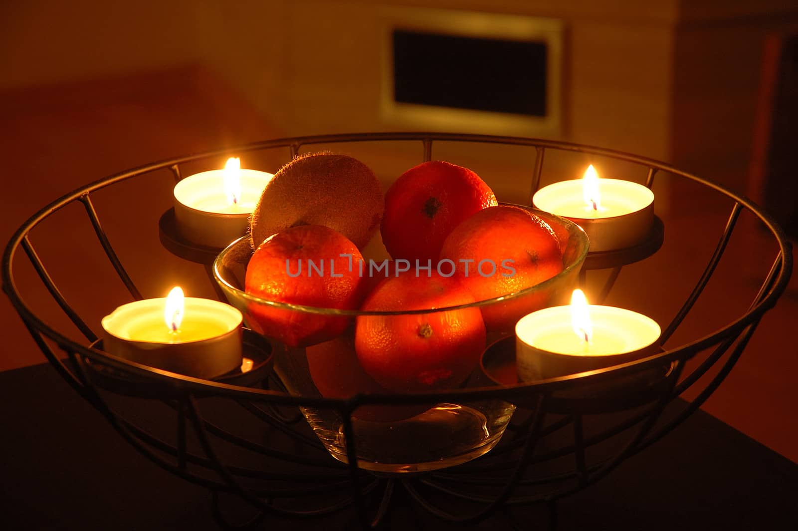 Fruits and candles in iron basket