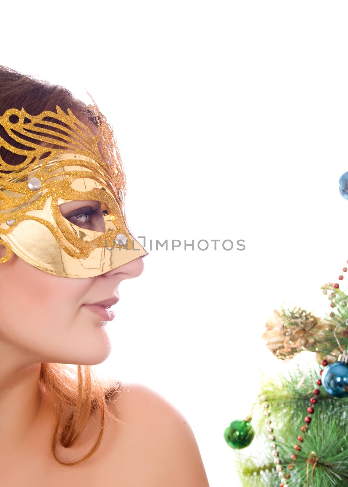 New masquerade mask on woman in the background of elegant Christmas tree isolated