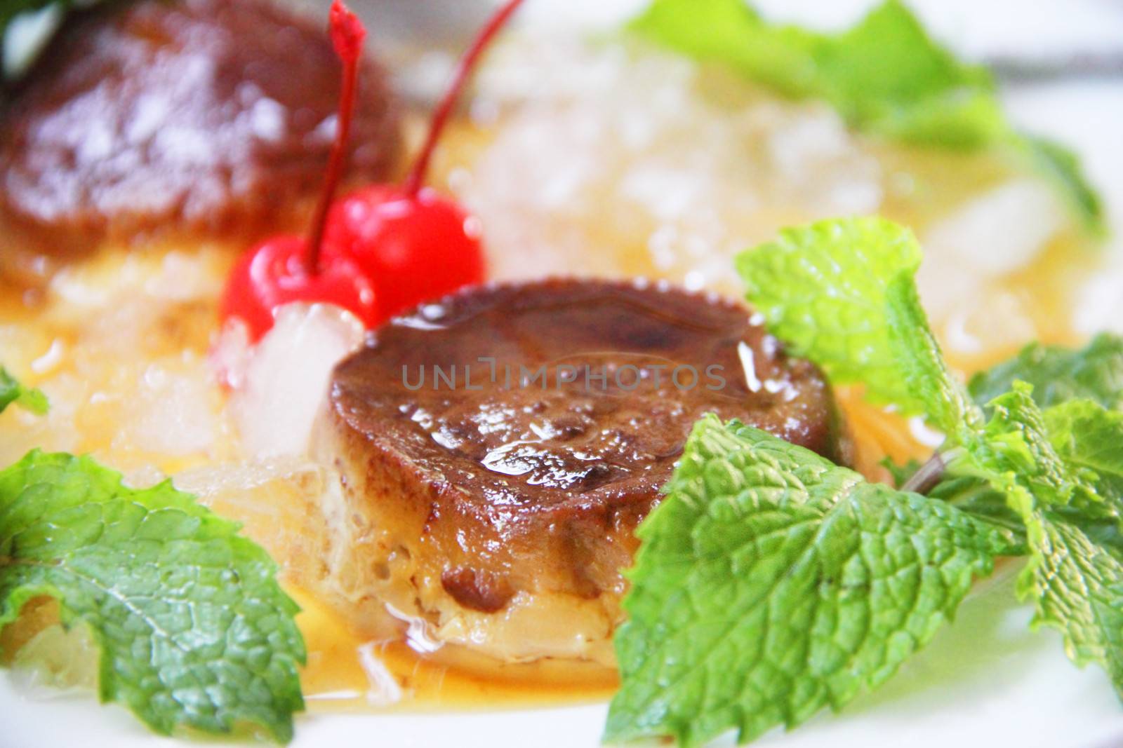 Traditional vietnam dessert cake with mint anf cherries