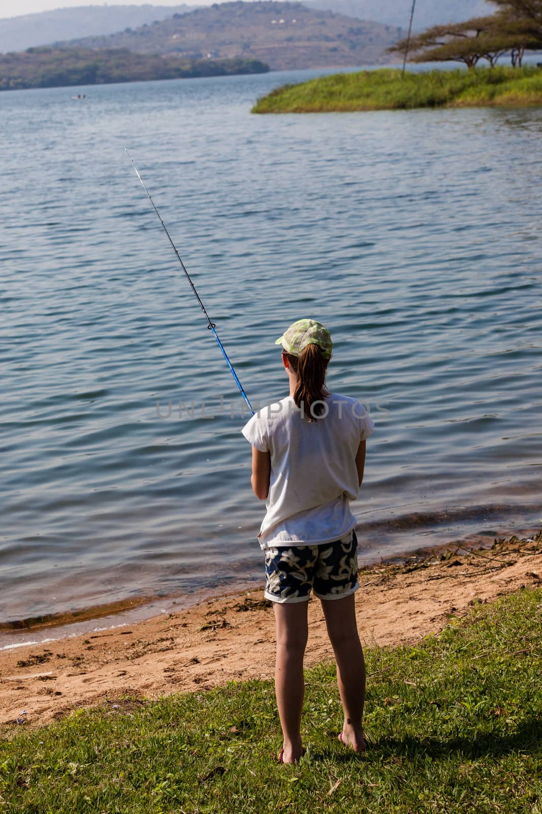 Girl Fishing Dam Waters by ChrisVanLennepPhoto