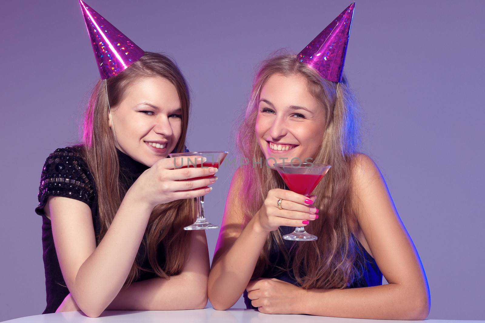 Close-up portrait of a smiling girl holding a cocktail