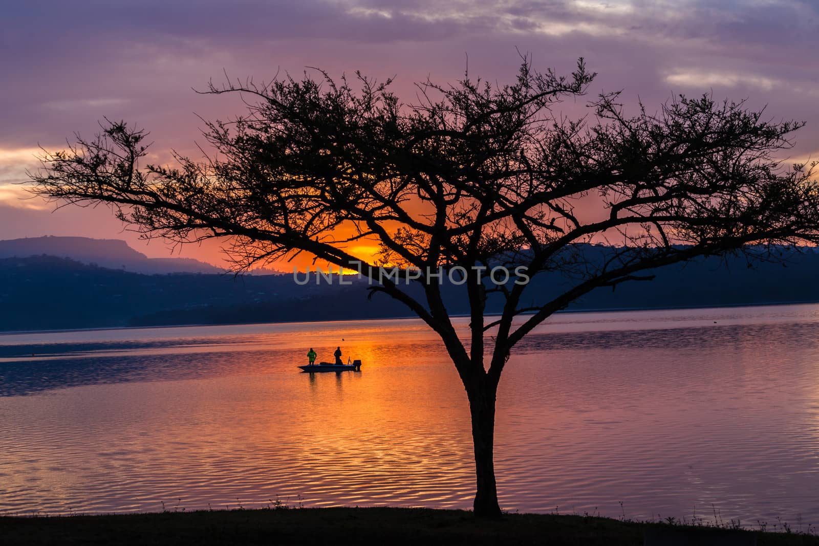 Dawn color reflections fishermen boat waters