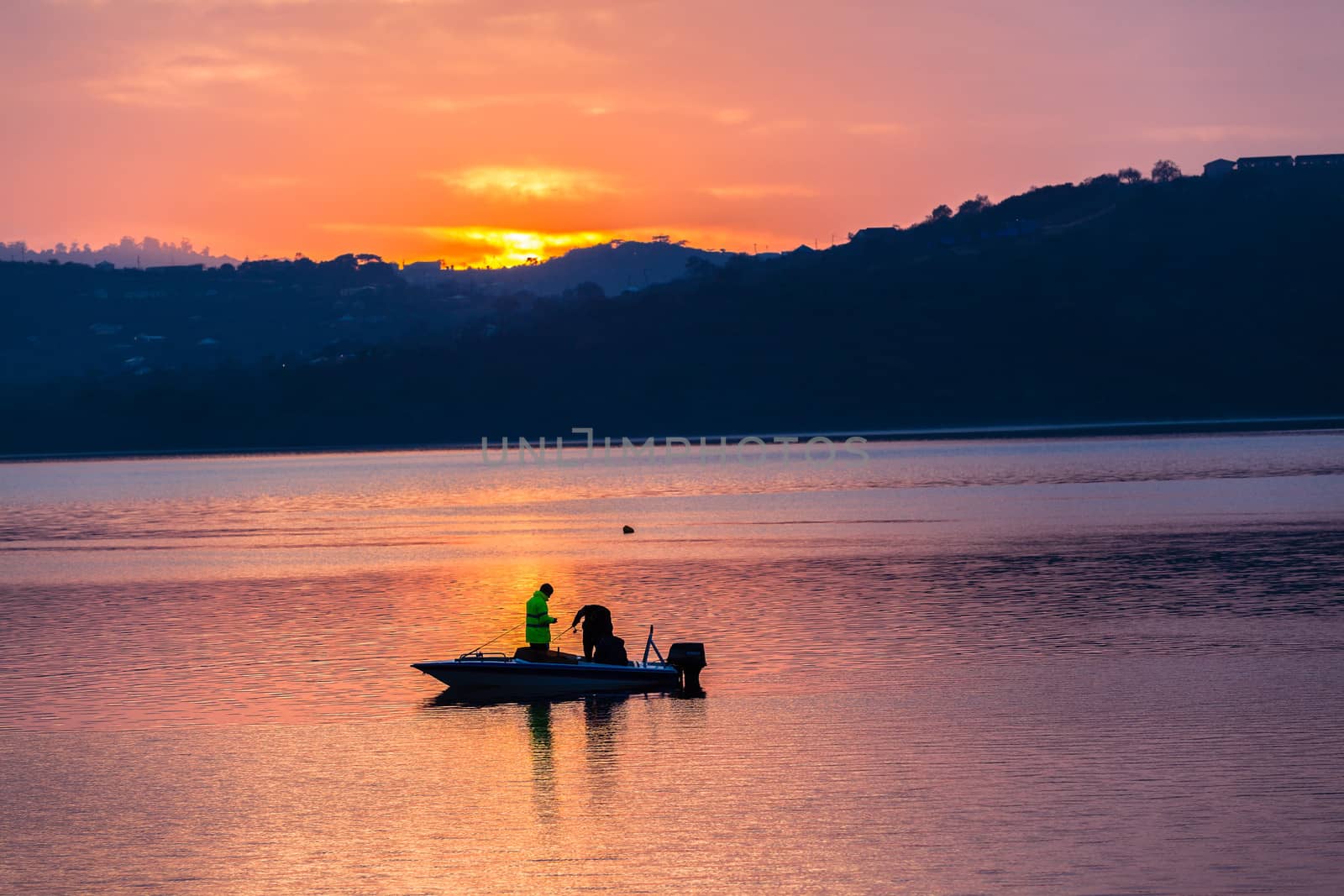 Dawn color reflections fishermen boat waters