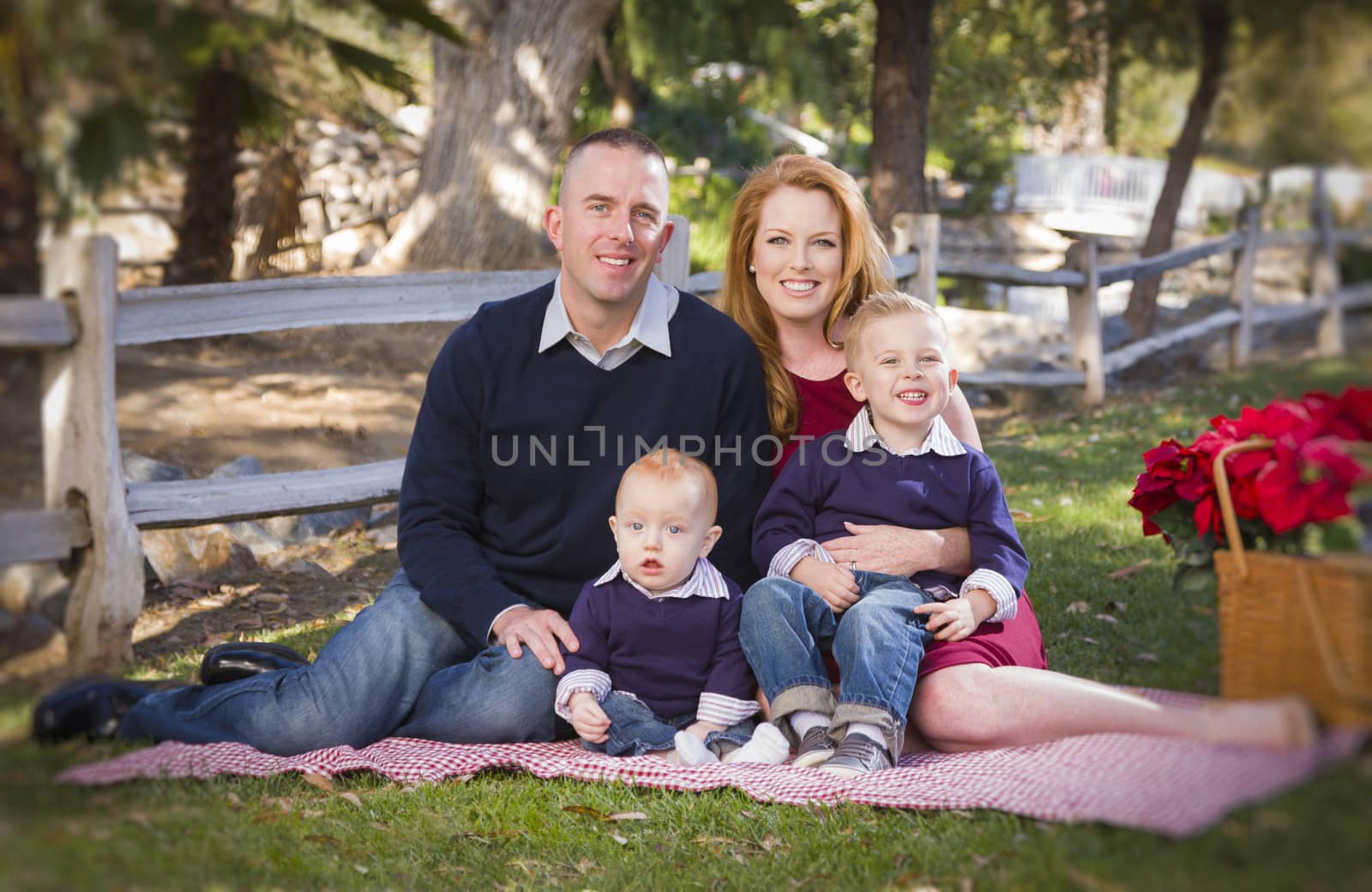 Beautiful Small Young Family Holiday Portrait in the Park.