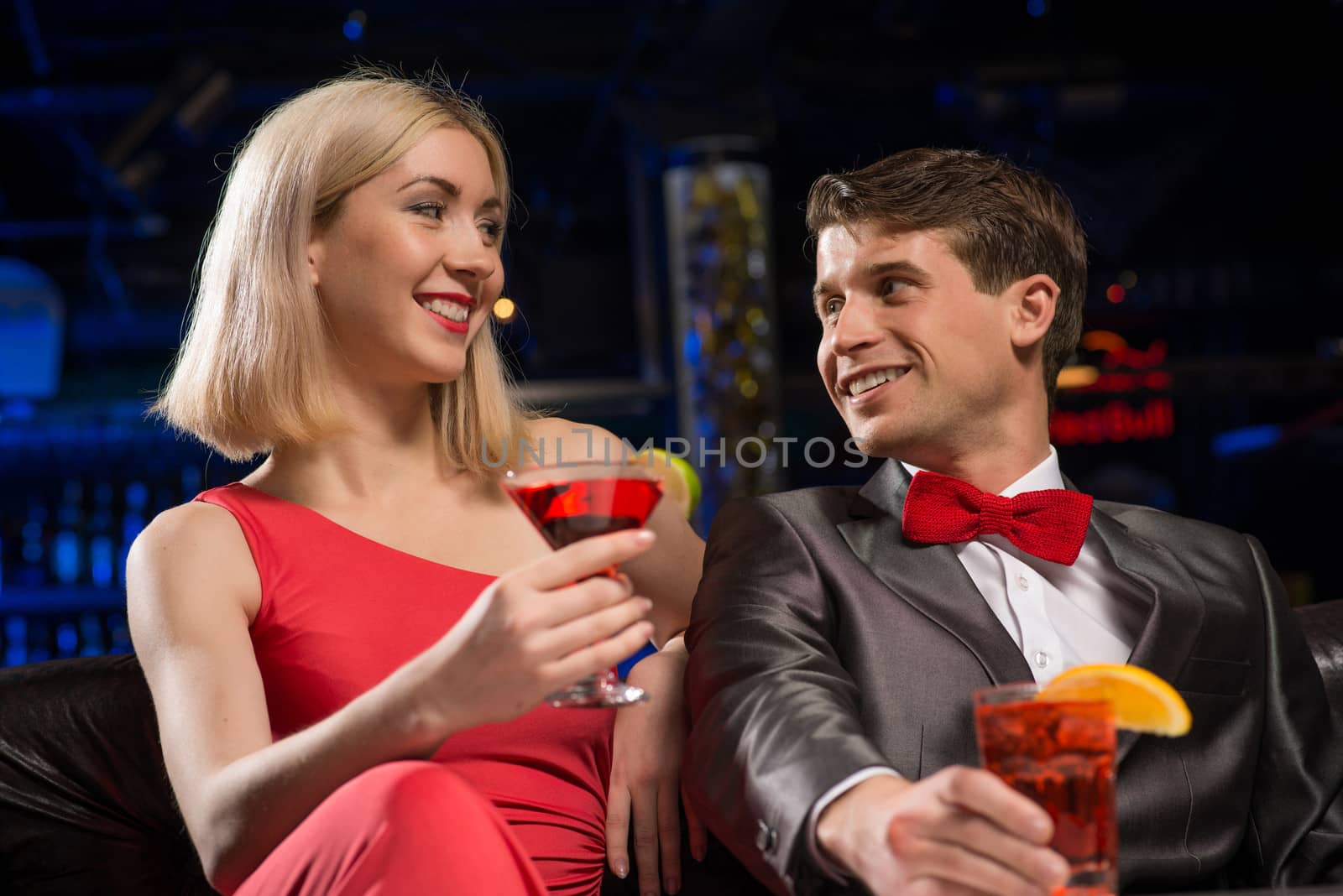 Young couple talking in a nightclub, have fun