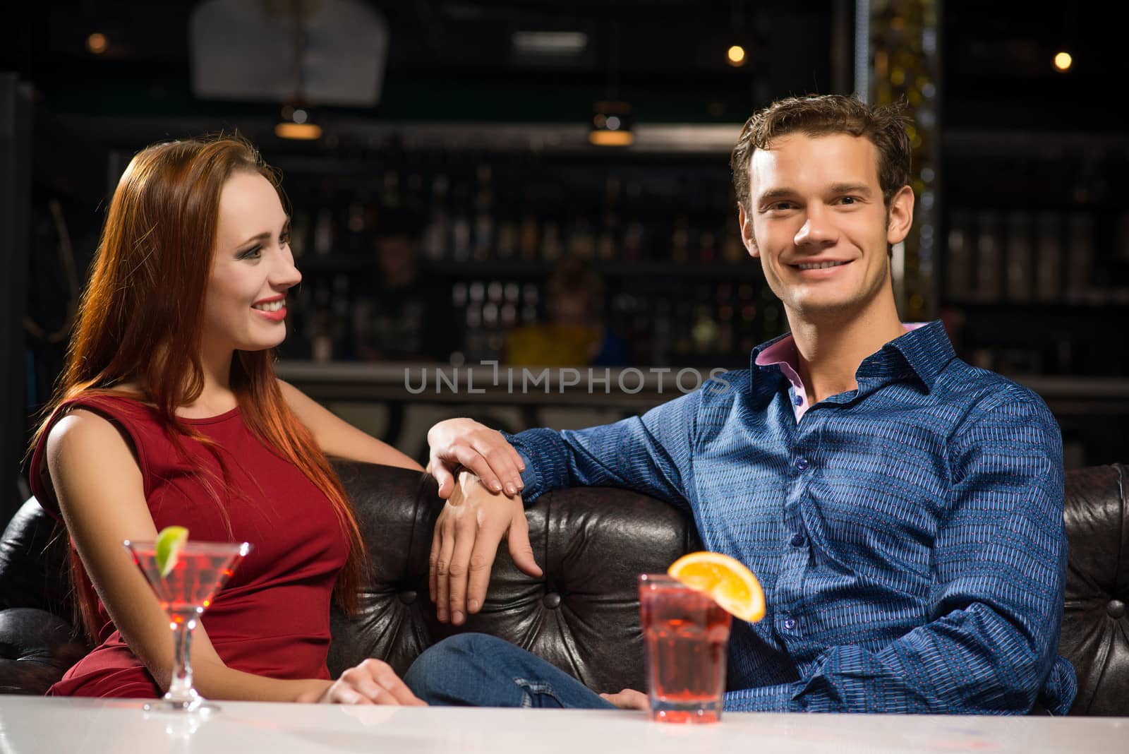 Young couple talking in a nightclub, have fun