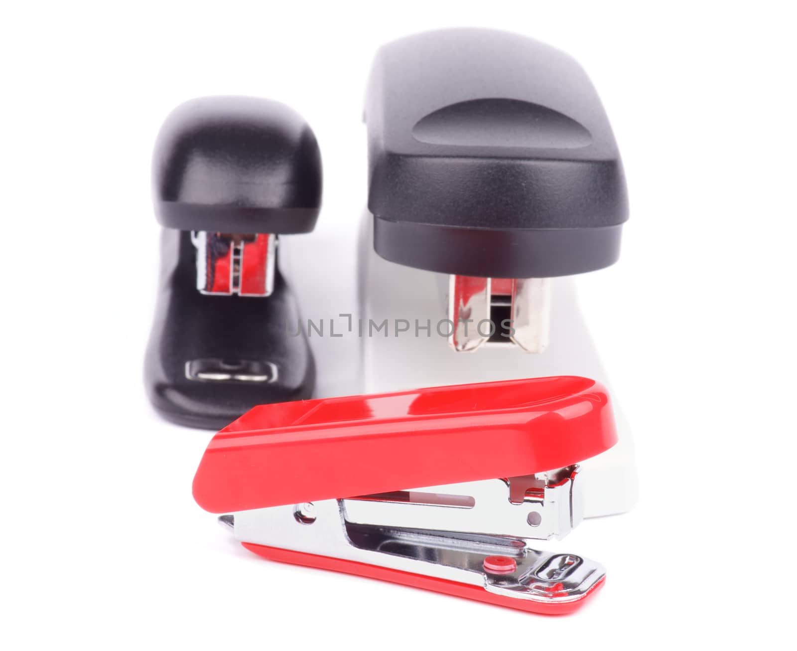 Arrangement of Three Staplers isolated on white background