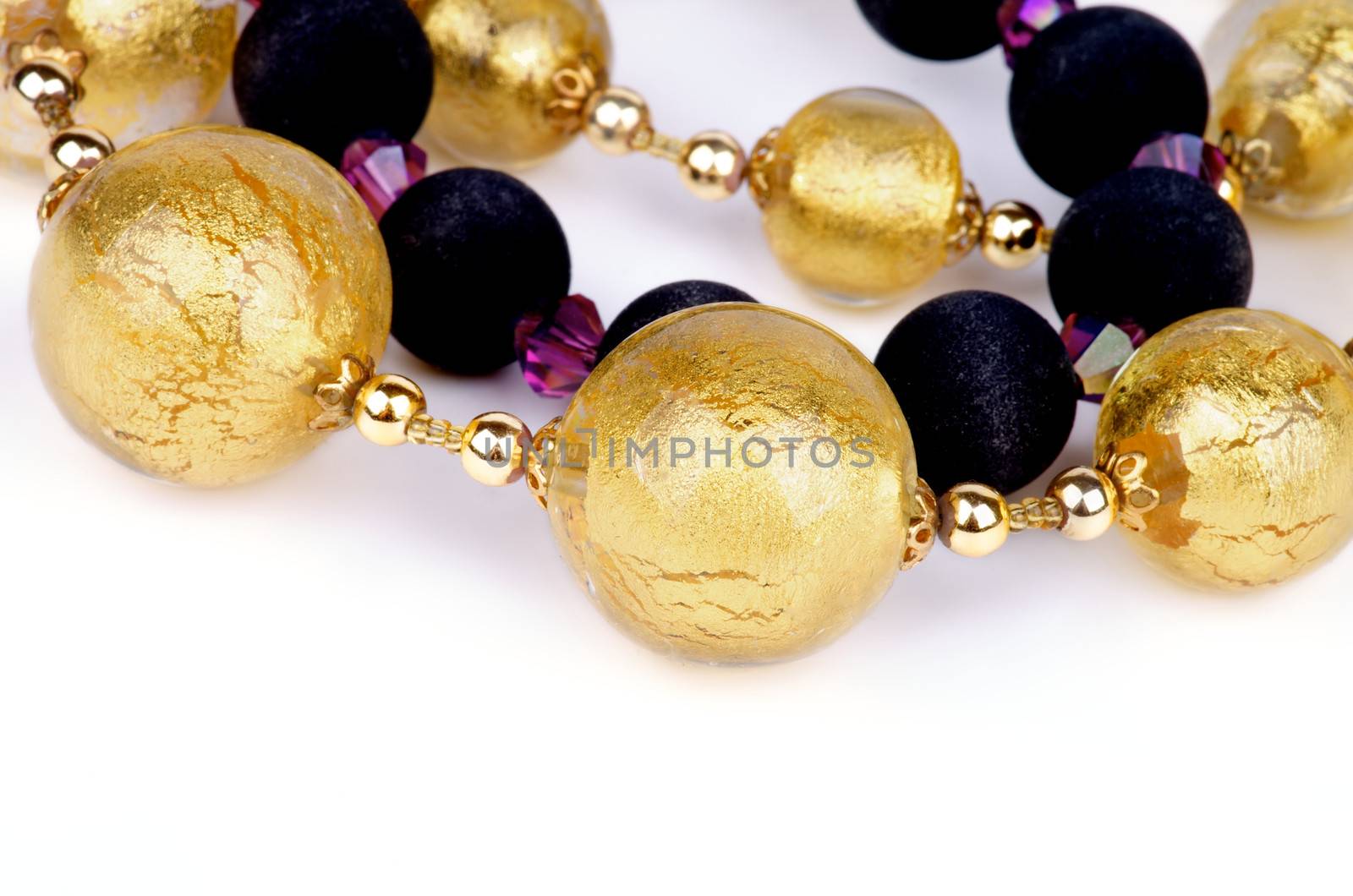 Arrangement of Gold and Black Jewelry Necklace isolated on white background