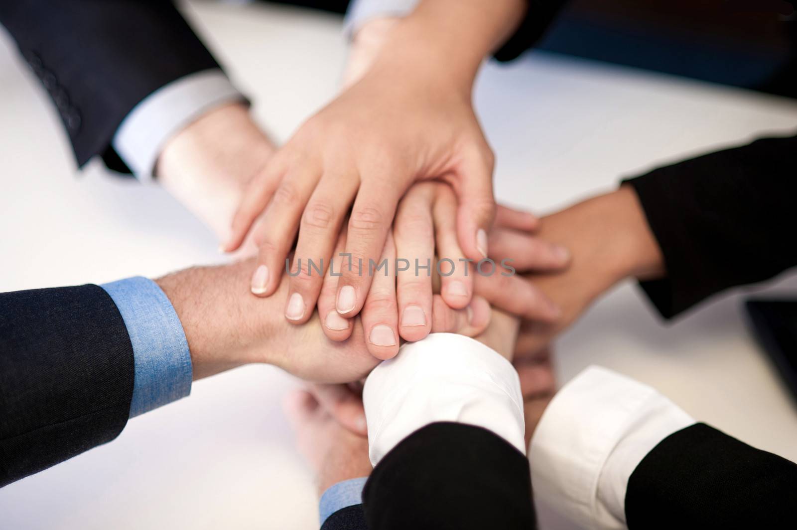 High angle view of business people stacking hands
