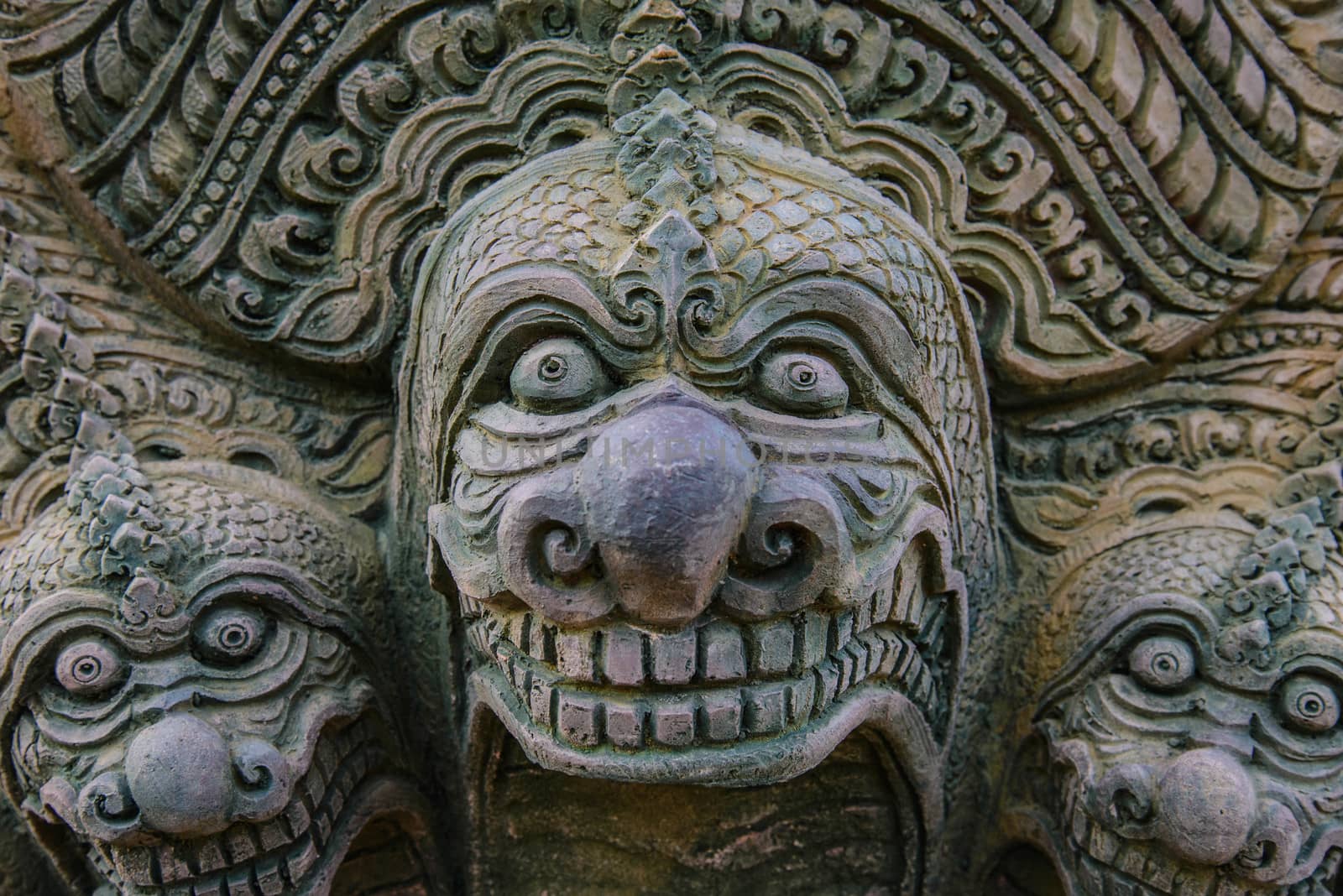 Stone statue on the wall of the temple in Thailand.