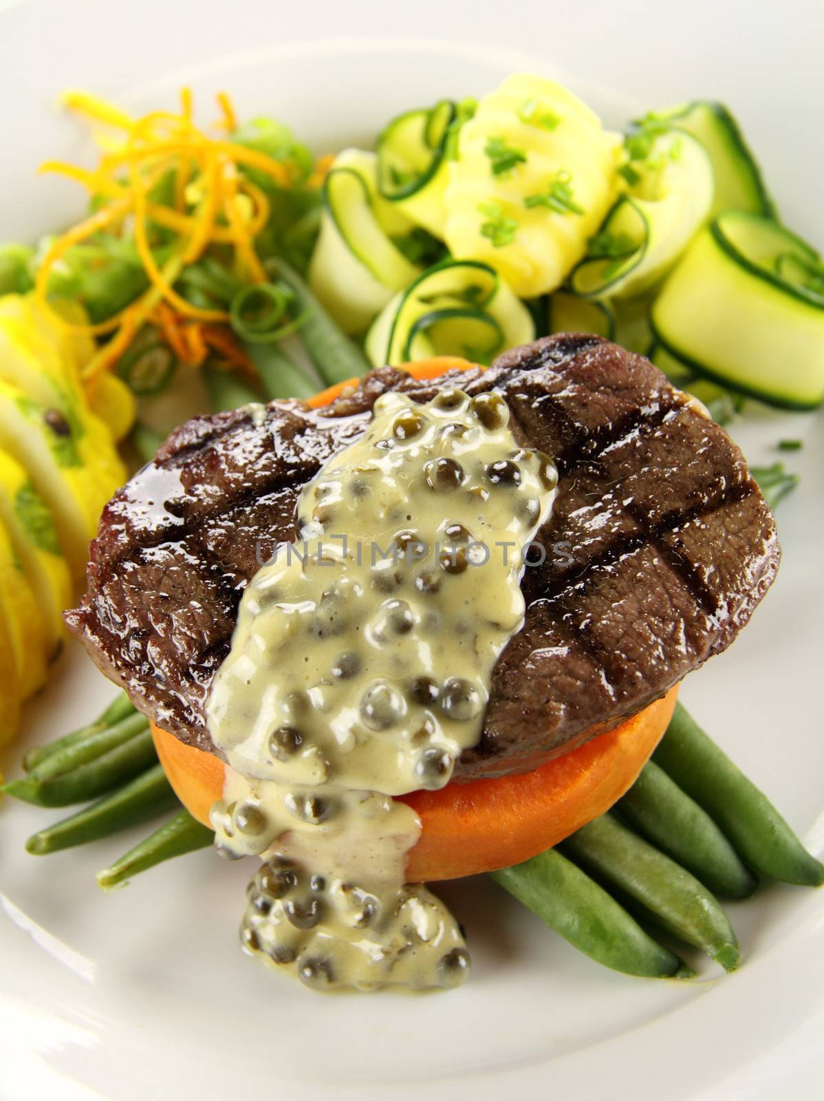 Chargrilled steak on sweet potato with green peppercorn sauce.