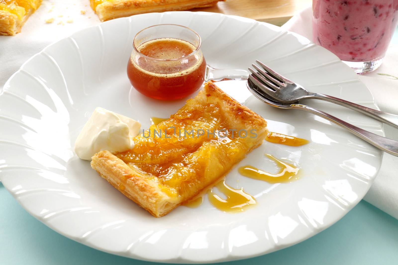 Delicious spiced pineapple galette served with cream and pineapple syrup.