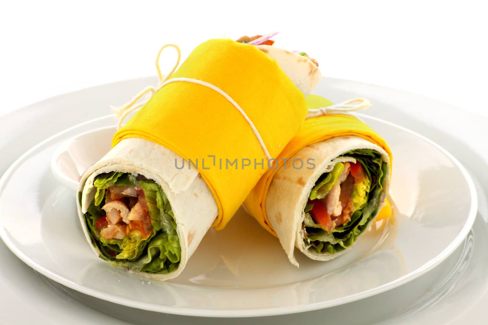 Delicious spicy chicken wraps in tortillas ready to serve.