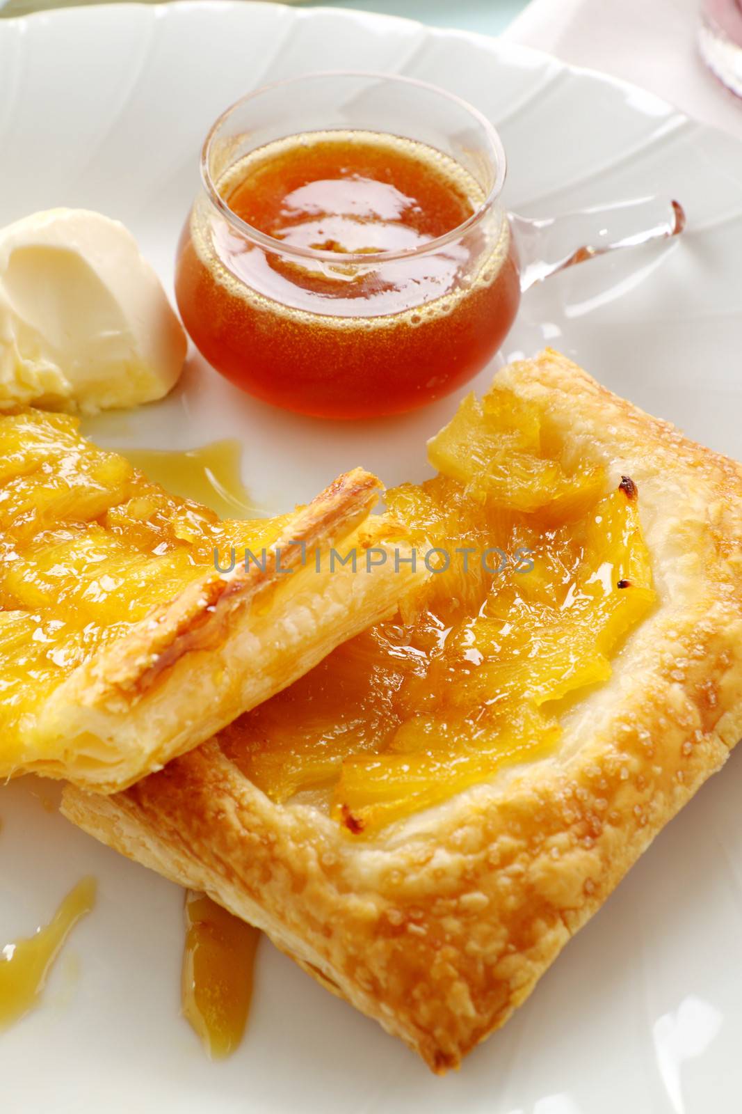 Delicious spiced pineapple galette served with cream and pineapple syrup.