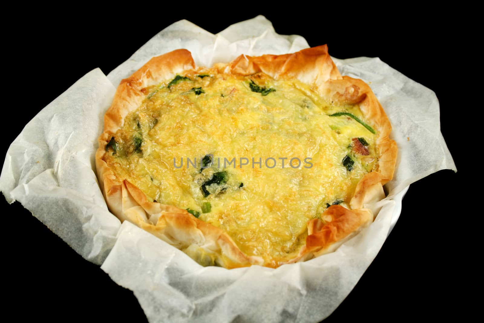 Freshly baked spinach and bacon quiche straight from the oven.