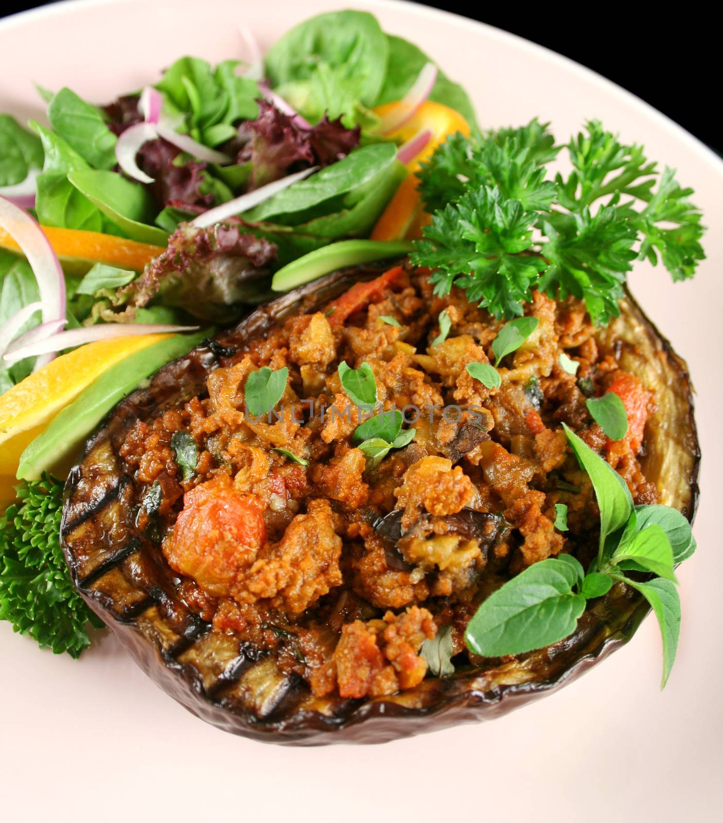 Egg plant stuffed with bolognaise with side salad and garnish.