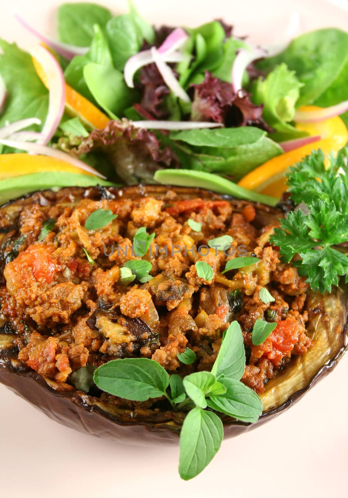 Egg plant stuffed with bolognaise with side salad and garnish.