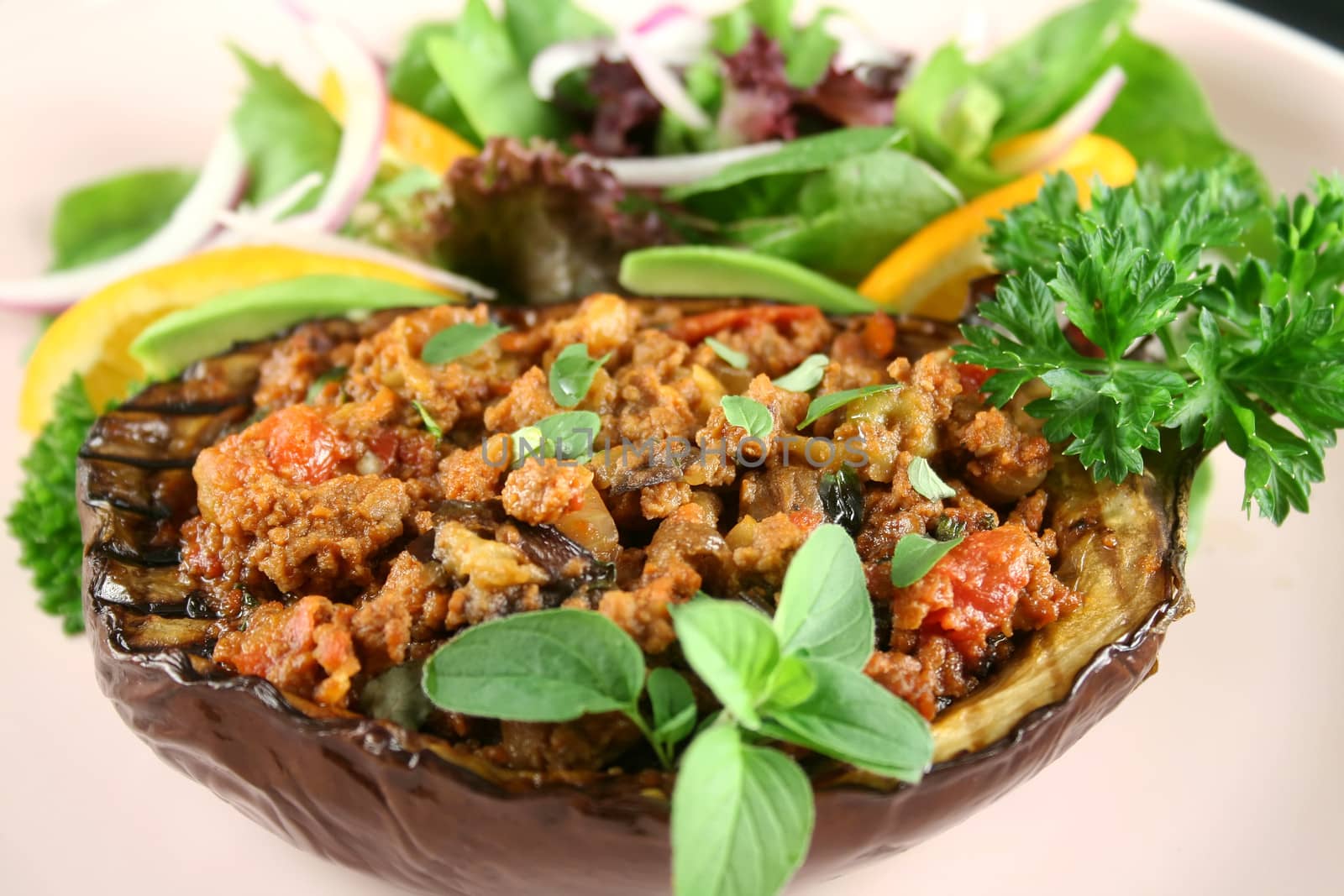 Egg plant stuffed with bolognaise with side salad and garnish.