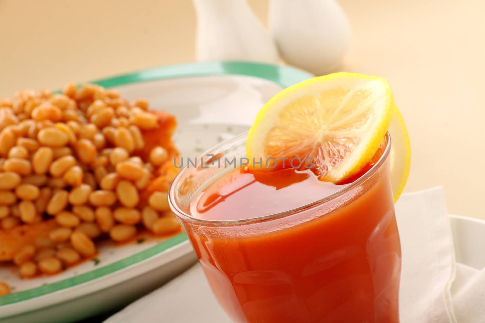 Refreshing tomato juice and lemon with baked beans for breakfast.