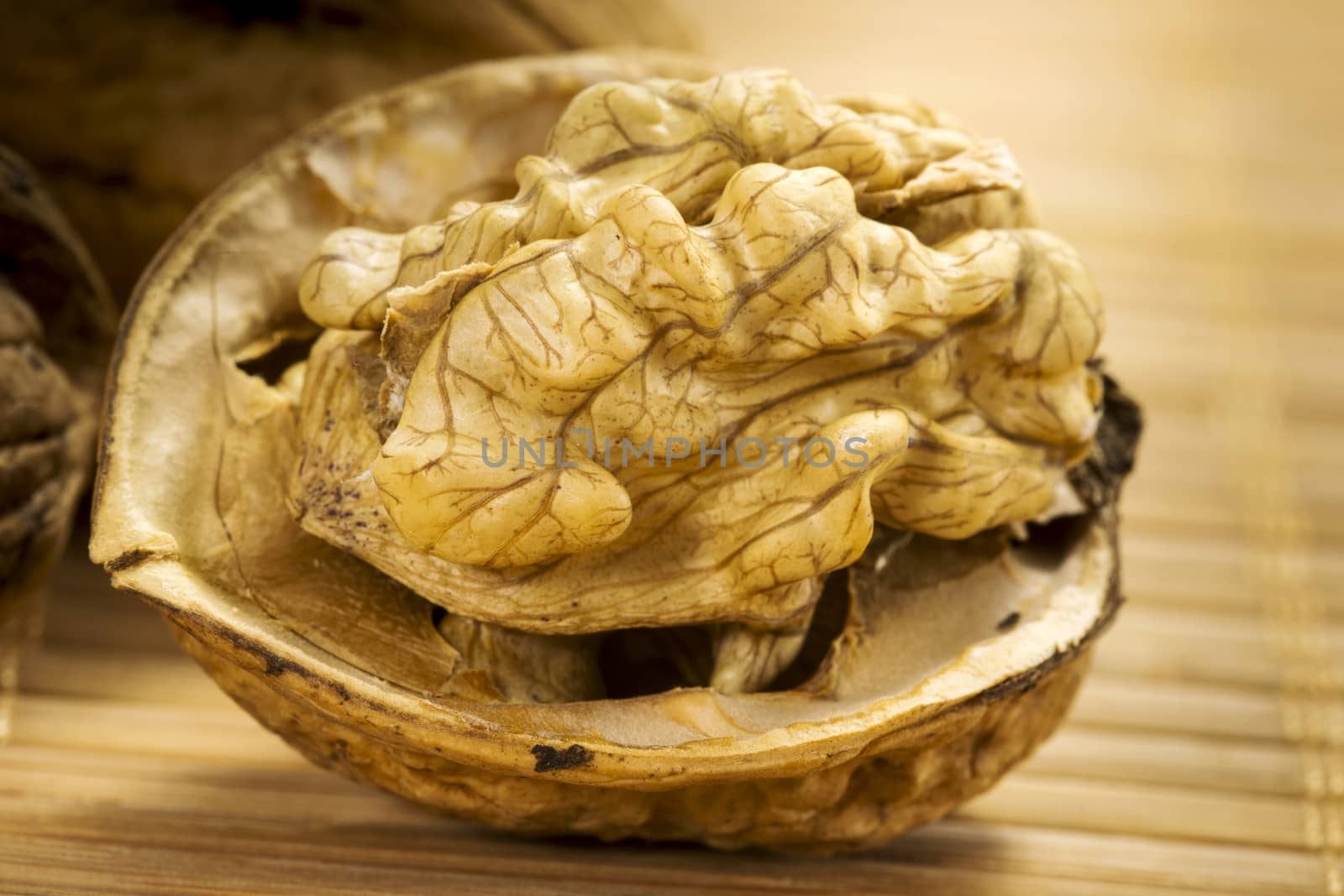 open cracked wallnut on brown bamboo background