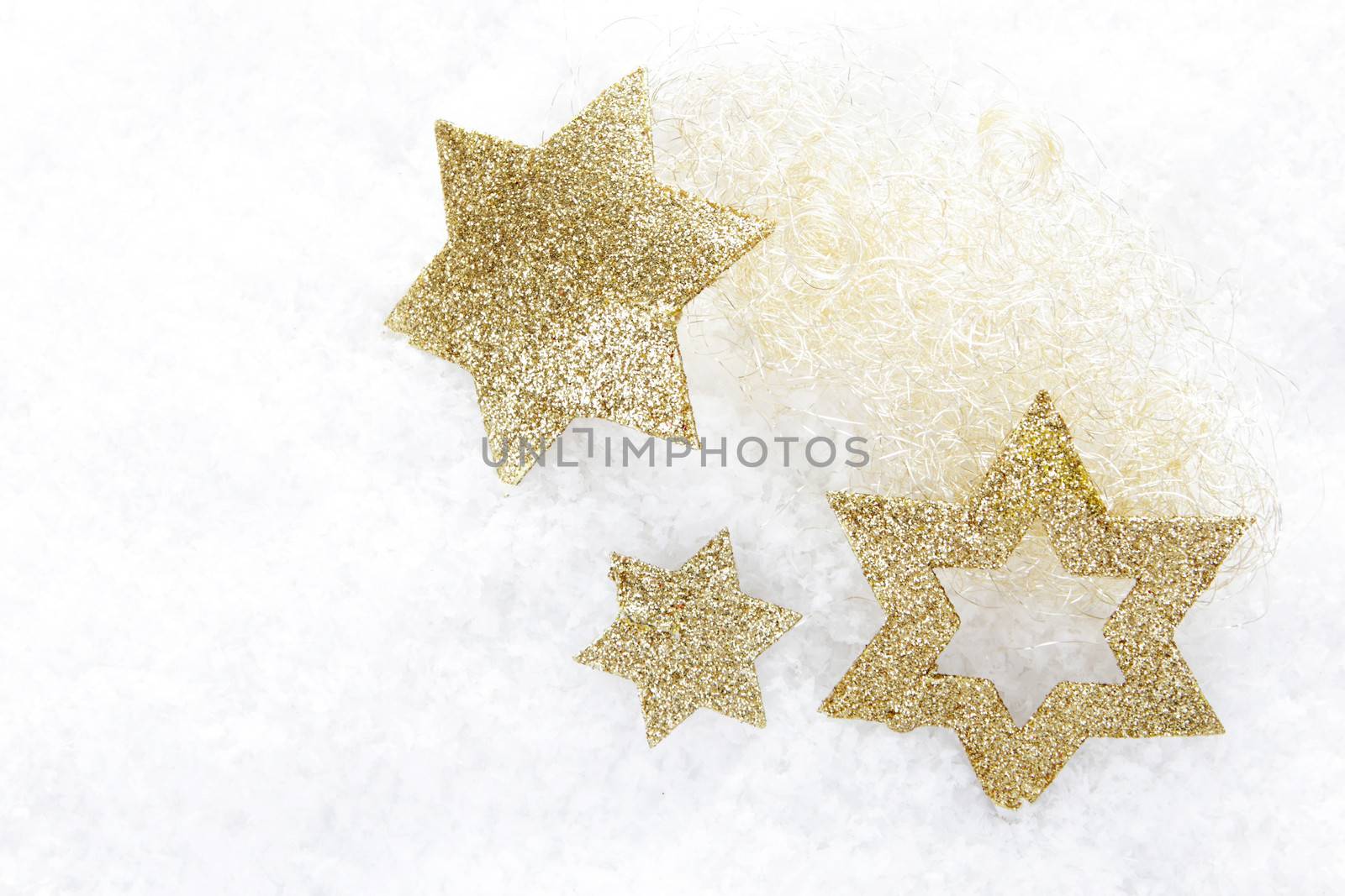 golden christmas stars on snow 