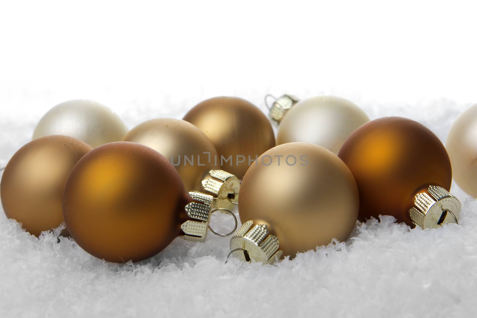 creme christmas balls on snow 