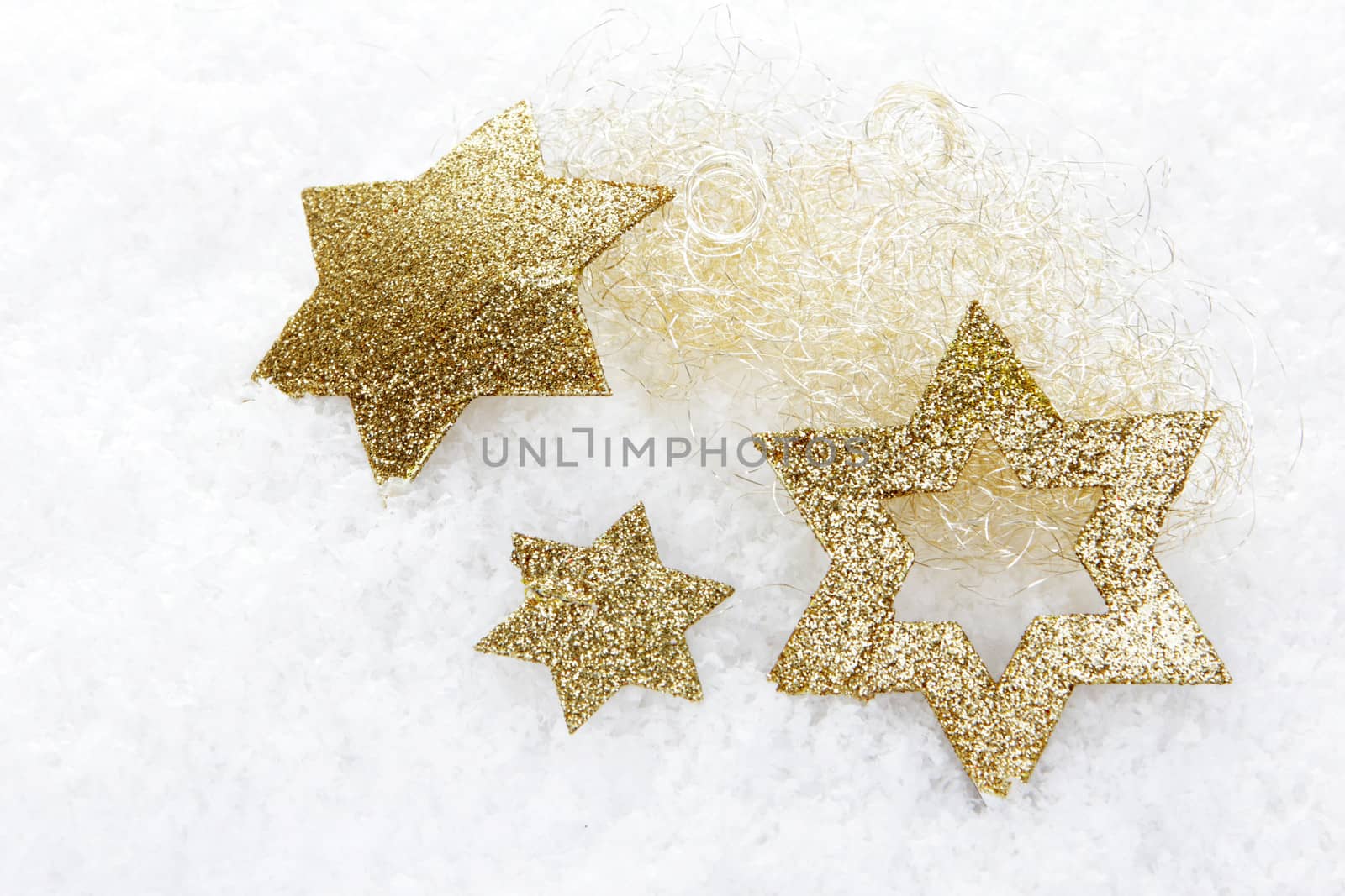 golden christmas stars on snow 