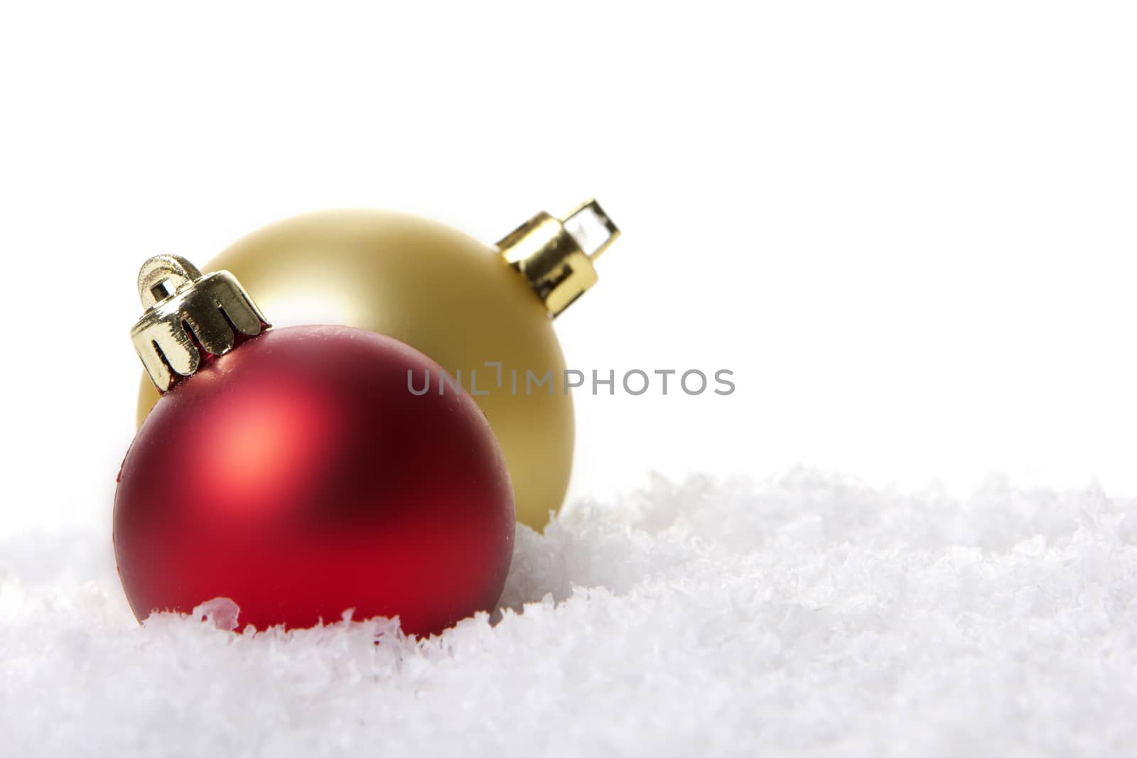 red and golden christmas balls on snow 