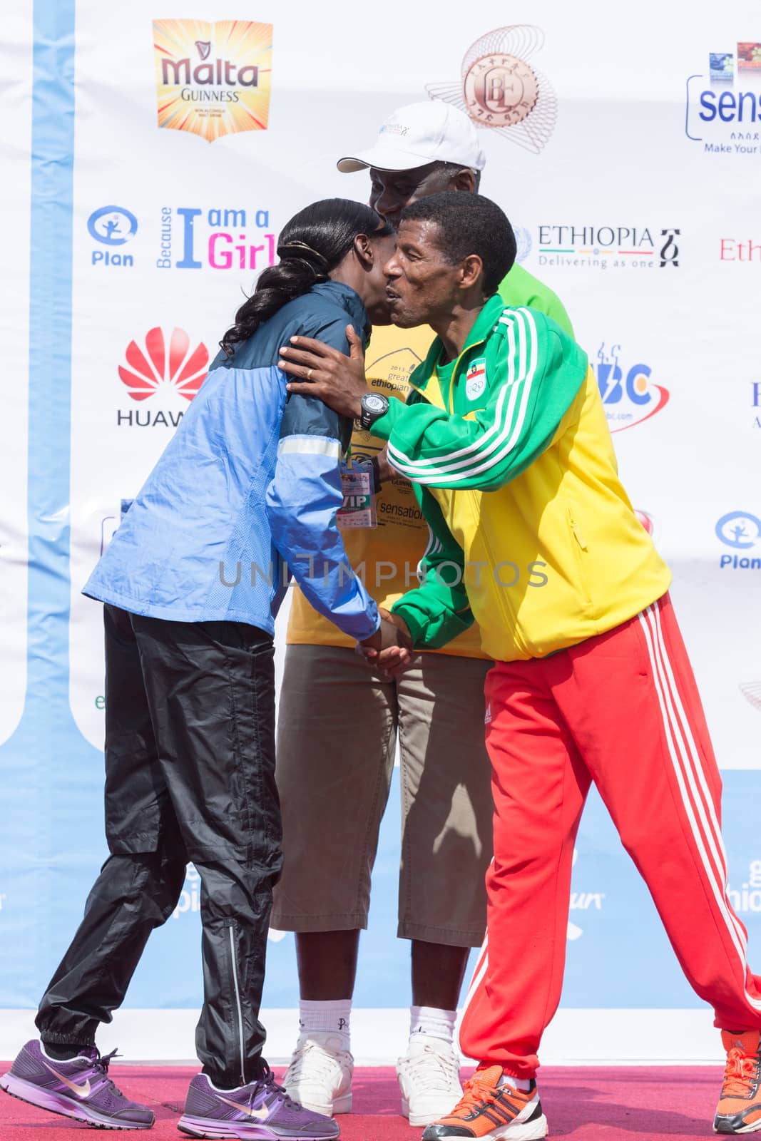 Addis Ababa, Ethiopia – November 24: World renowned athlete Haile Gebrselassie greets 2013 NY Marathon winner Priscah Jeptoo on stage at the 13th Edition Great Ethiopian Run, 24th of November 2013 in Addis Ababa, Ethiopia.