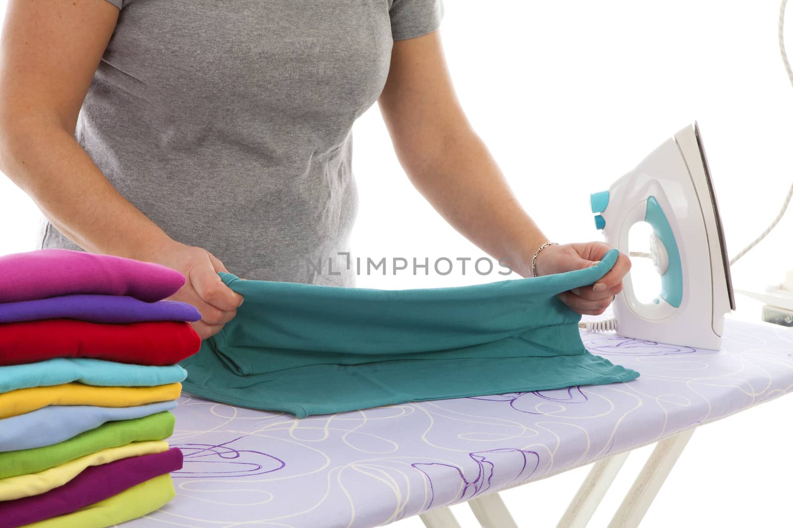 housewife is doing the ironing in closeup over white background