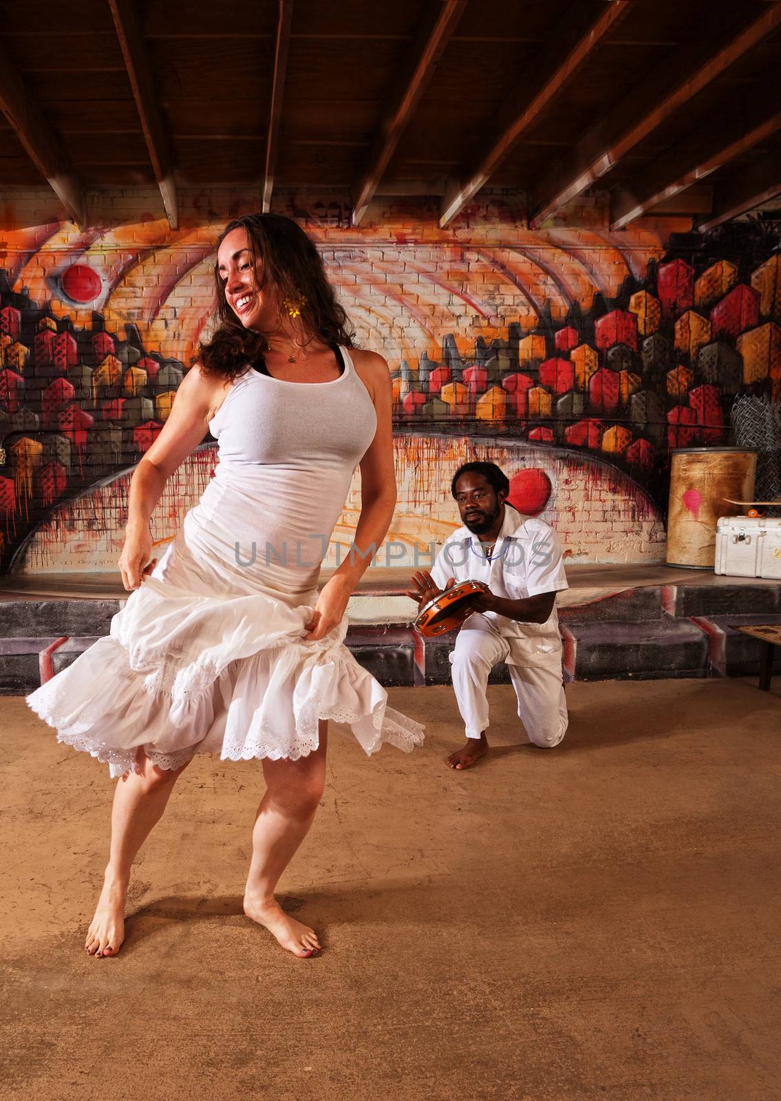 Happy Brazillian dancer and pandeiro performing indoors