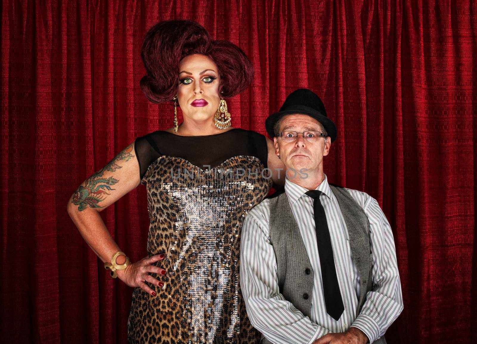 Odd couple drag queen with man at curtain