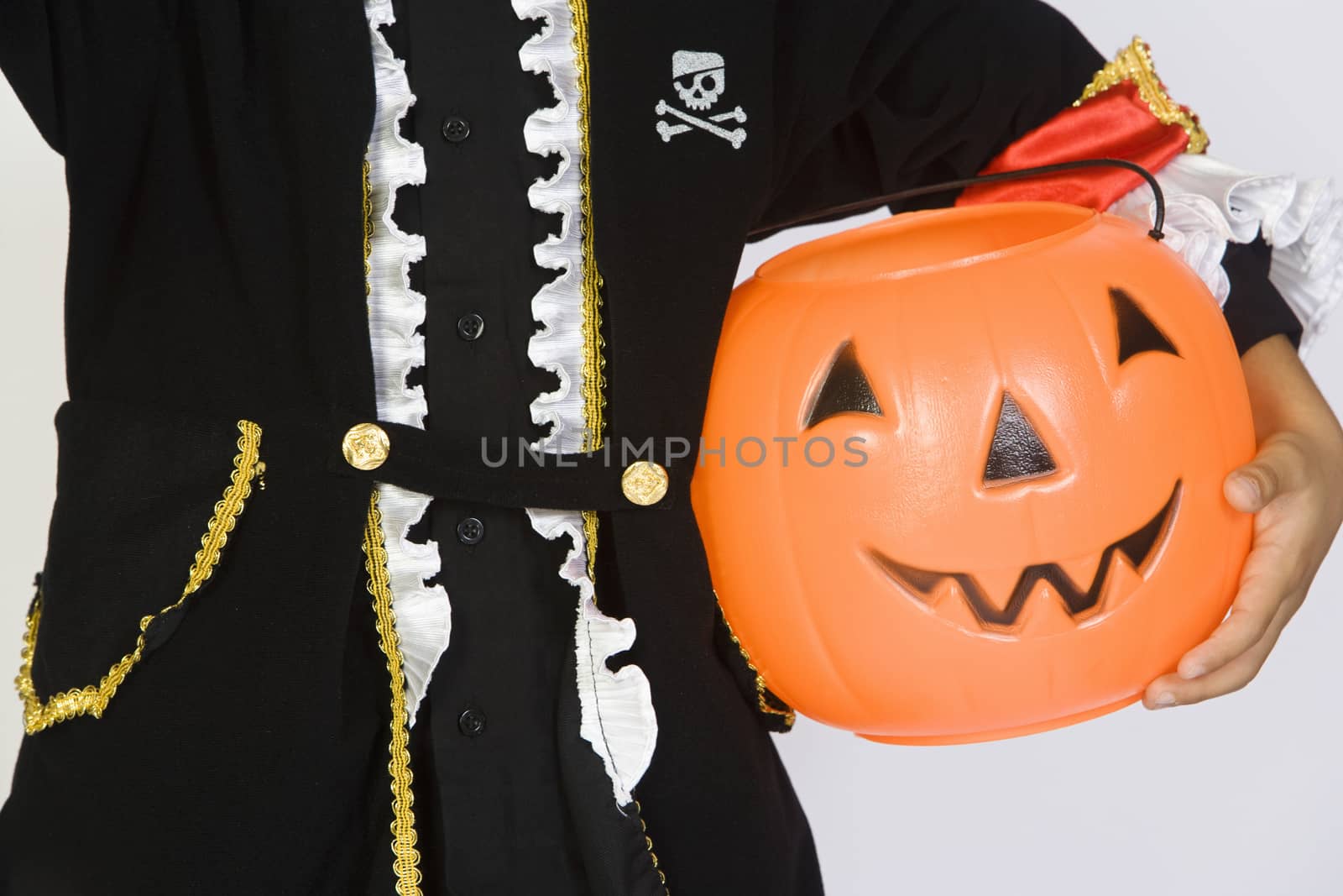 Boy (7-9) wearing Halloween costume with jack-o-lantern by moodboard
