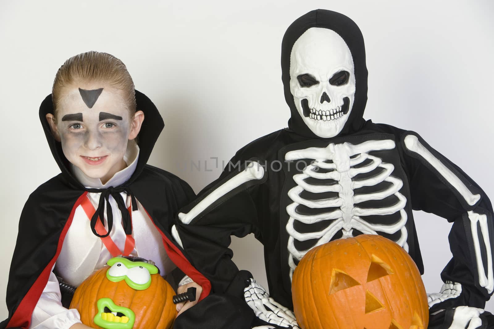 Portrait of boys (7-9) wearing Halloween costumes by moodboard