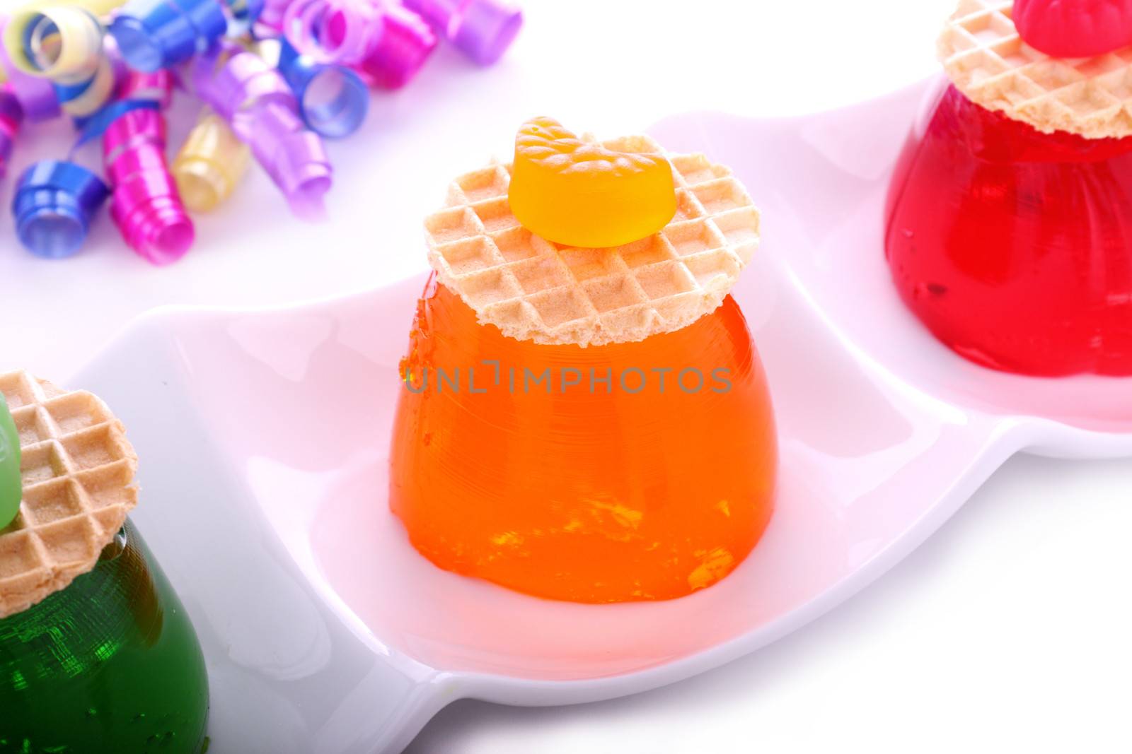 Delicious orange jelly with candy and wafer on top.