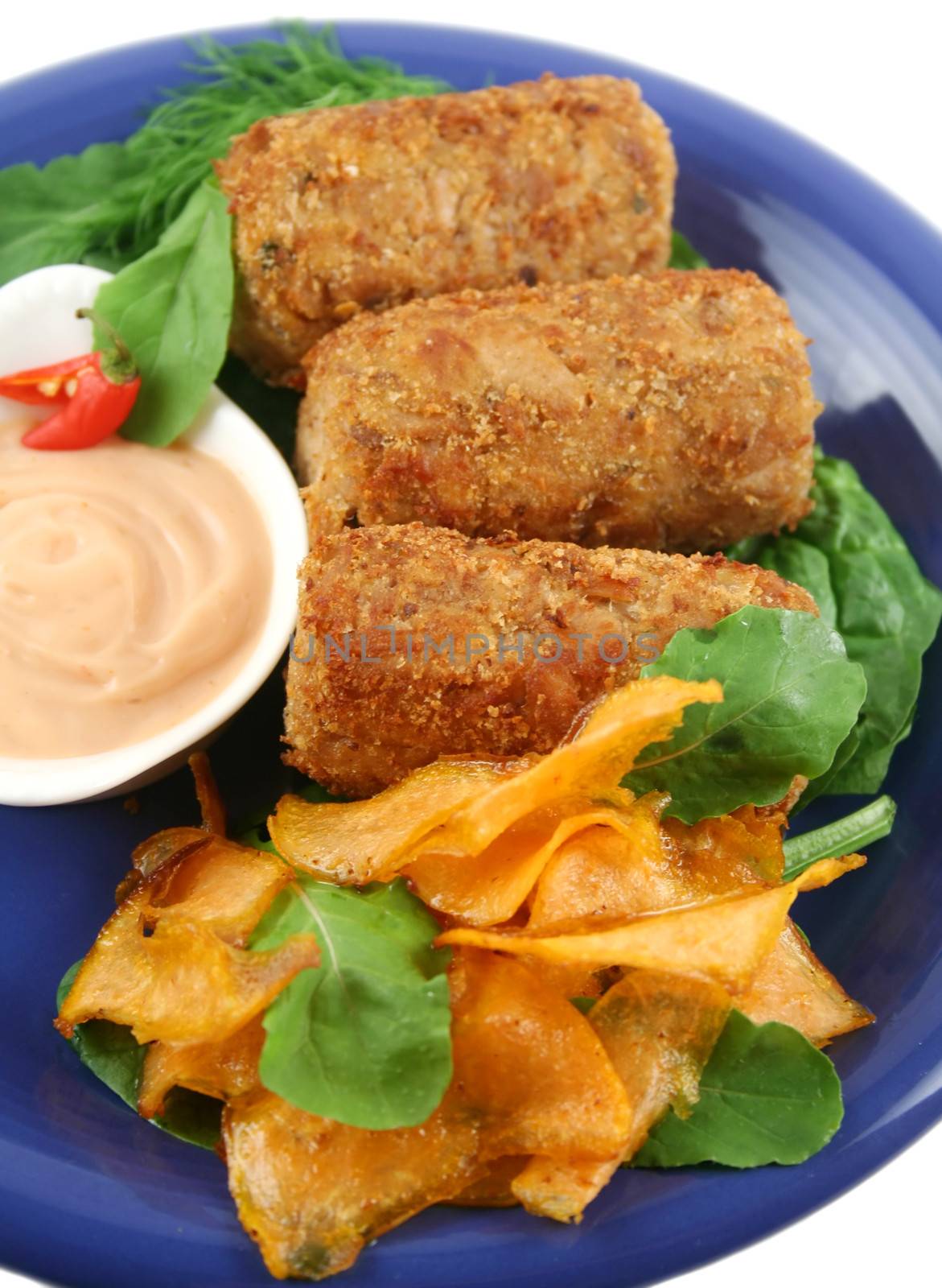 Crumbed tuna croquettes with sweet potatoes and a rocket salad.