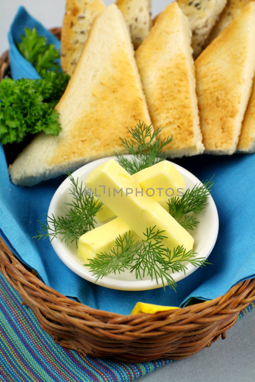 Crisp toast quarters with butter and Italian parsley.