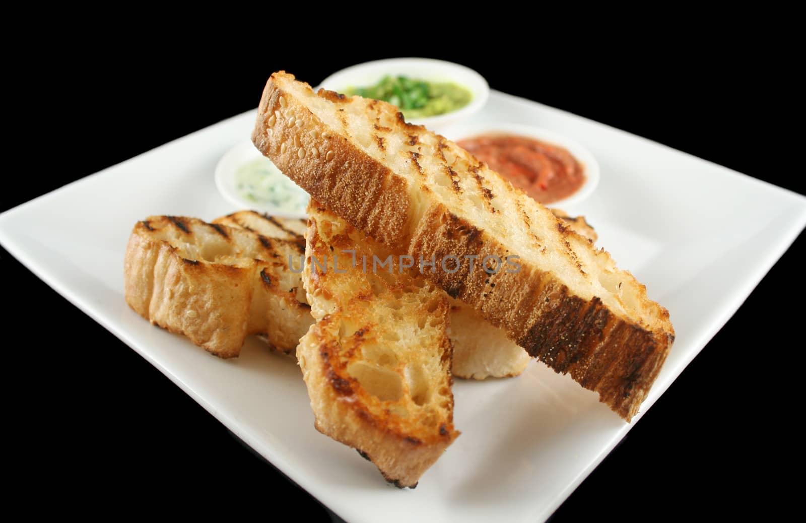 Delicious and colorful trio of dips with grilled Turkish bread.