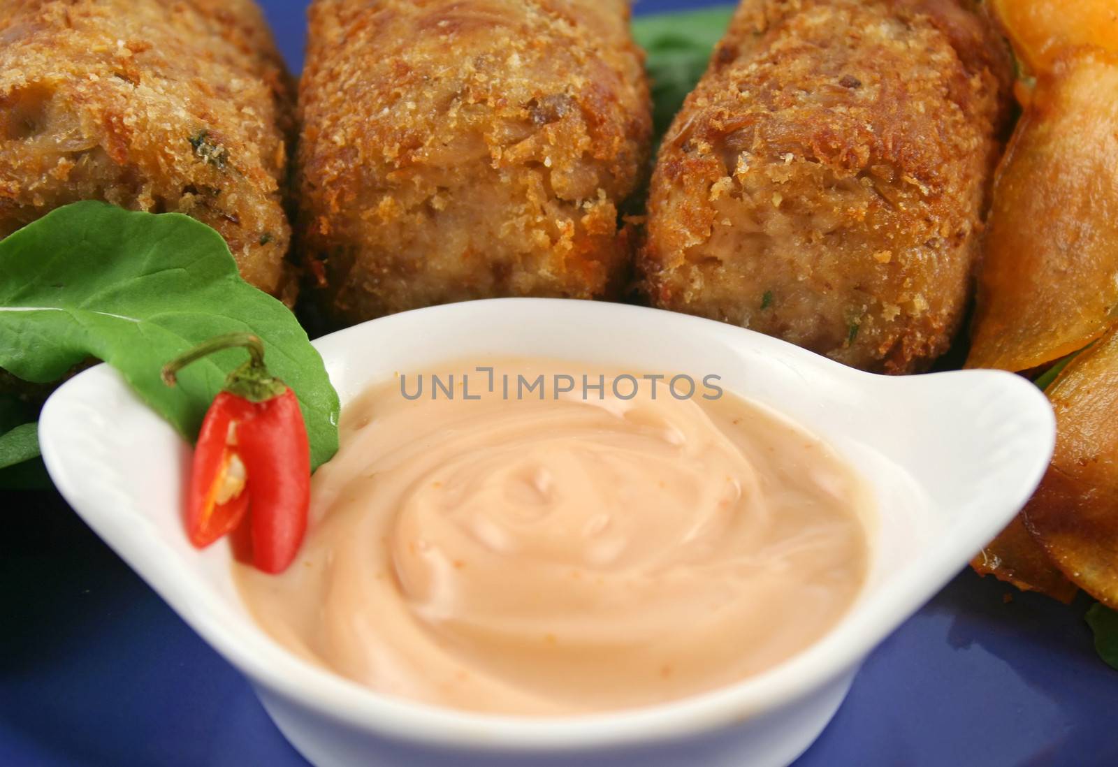 Crumbed tuna croquettes with sweet potatoes and a rocket salad.