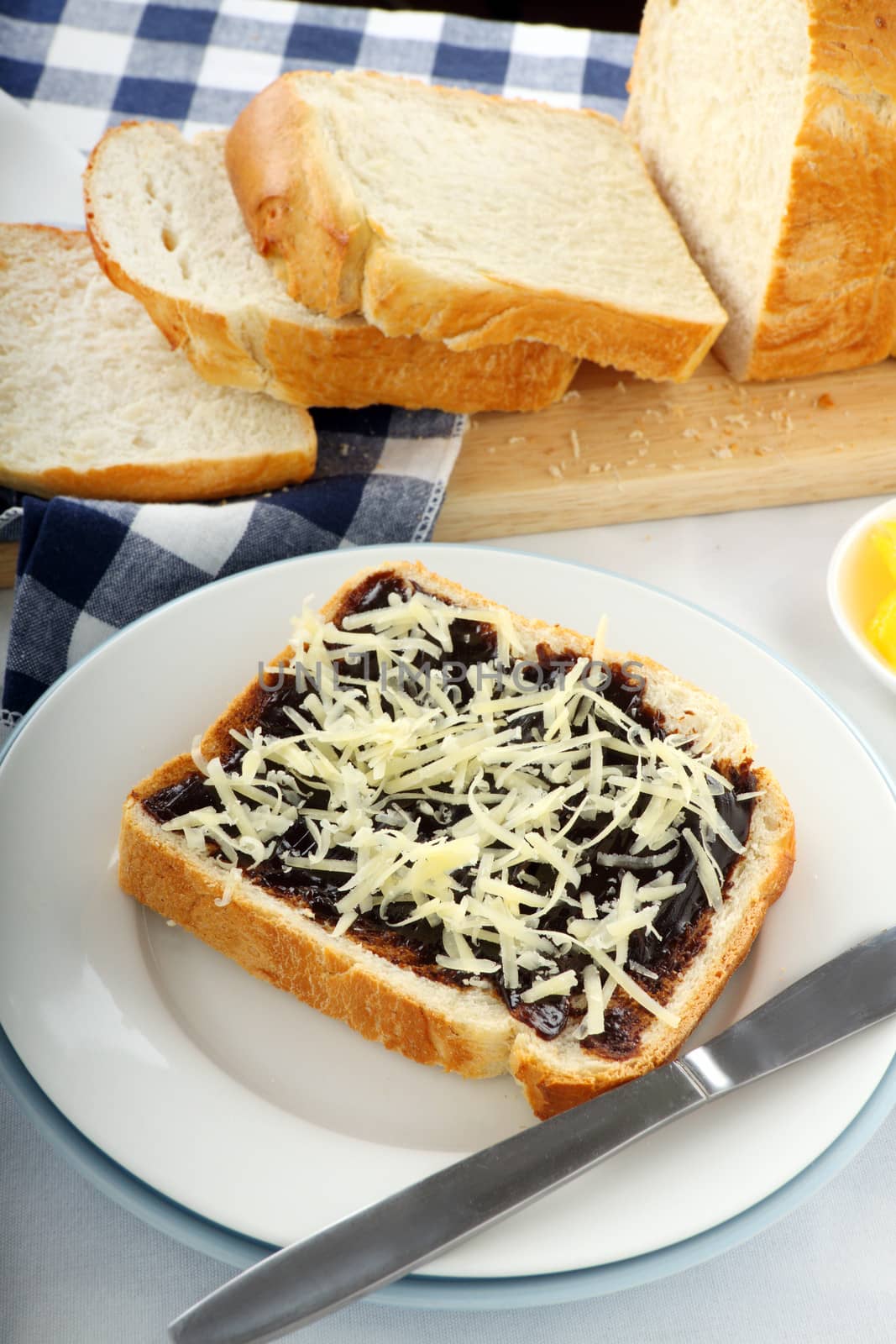 Vegemite sandwich with shredded cheese ready to serve.