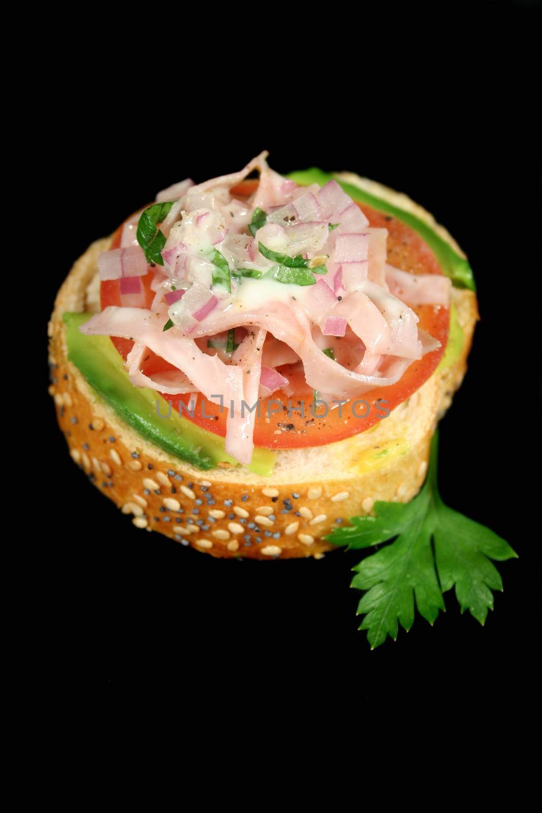 Tomato, avocado and ham bite with red onion mayo dressing.