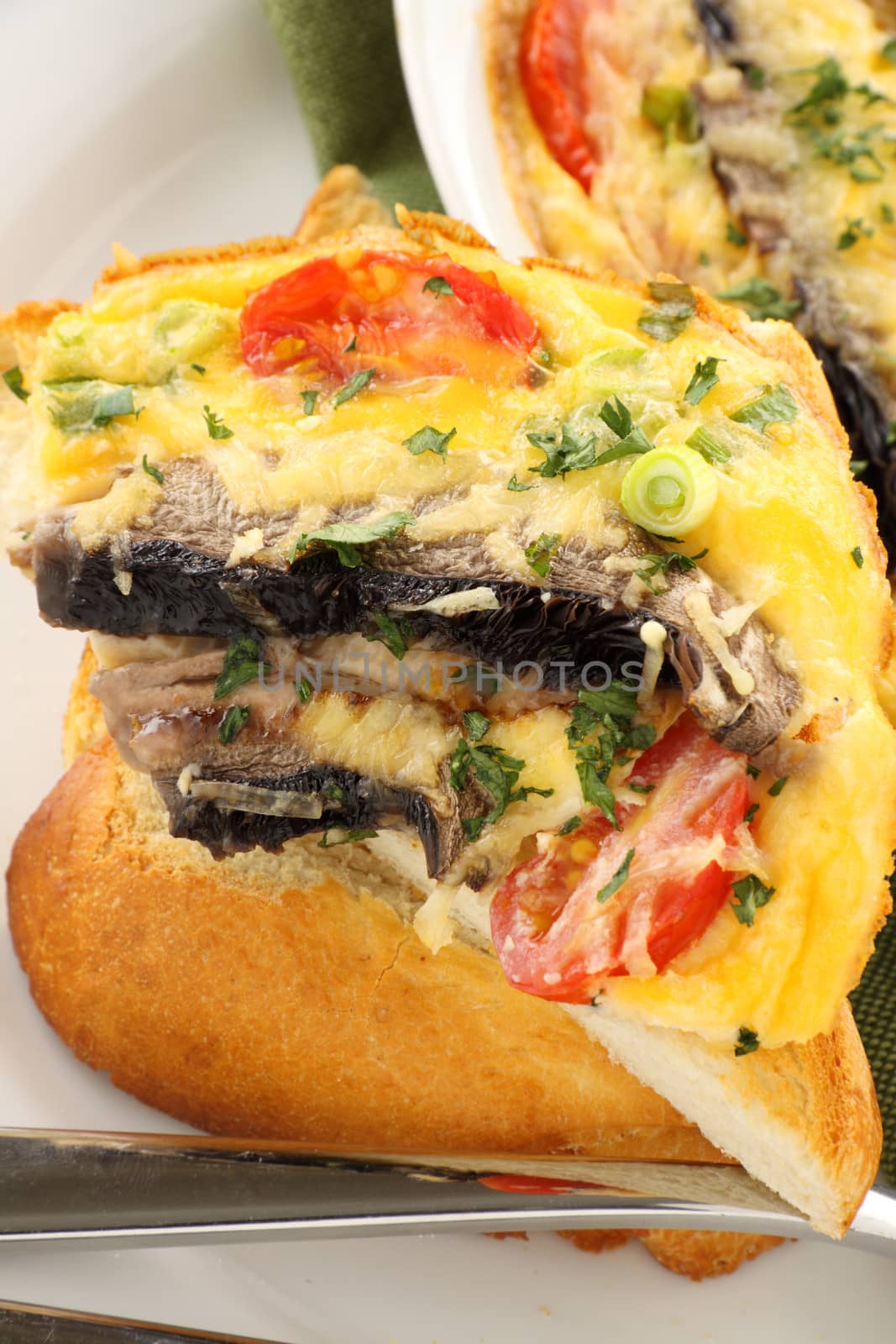 Delicious mushroom and tomato bake served on toast for breakfast.
