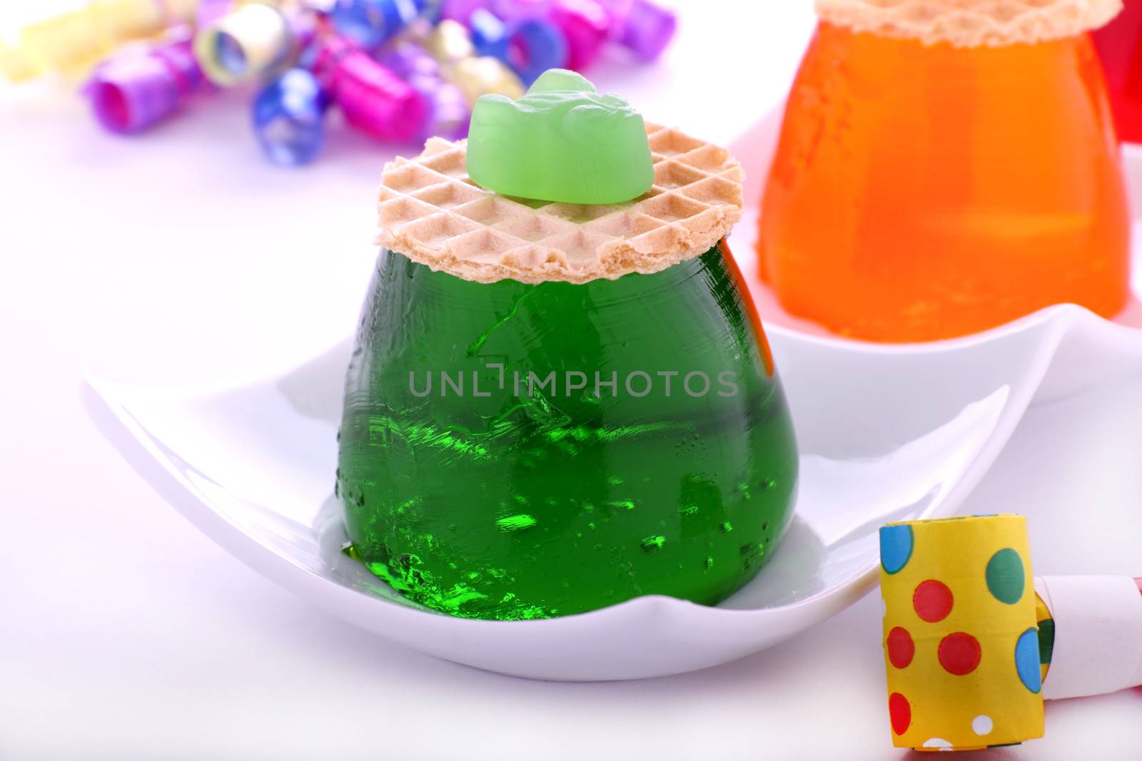 Lime flavored jelly with candy and wafer on top.