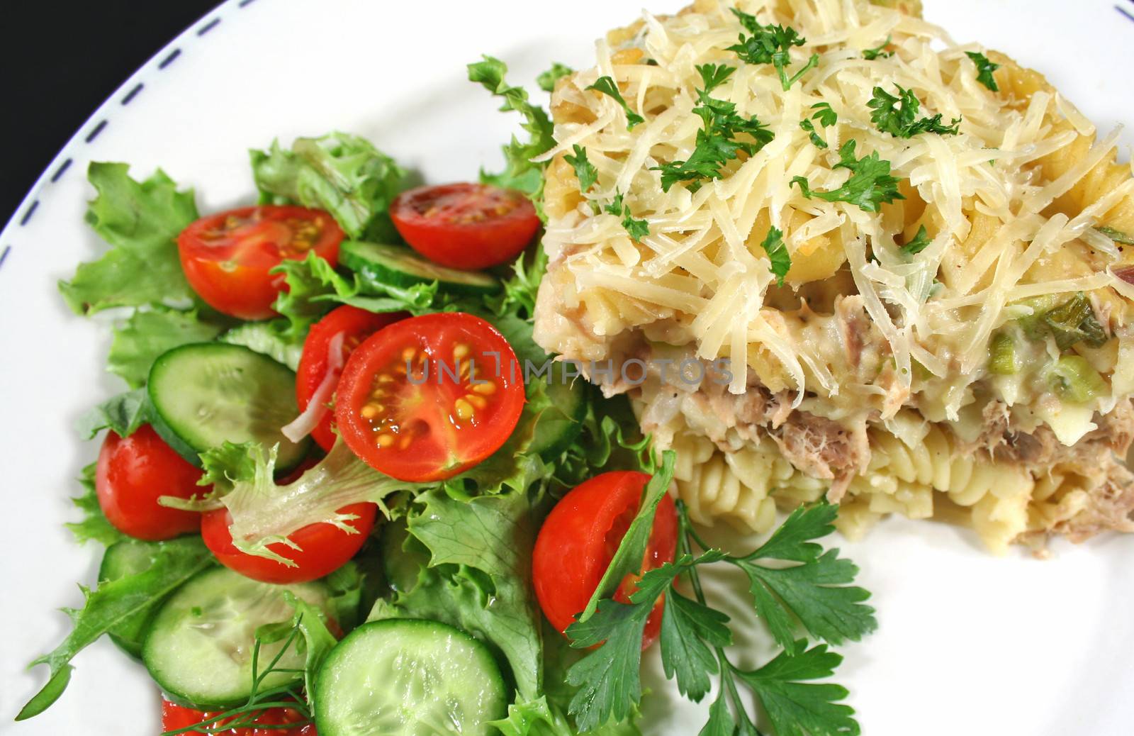 Delicious tuna and pasta bake with a tossed salad ready to serve.