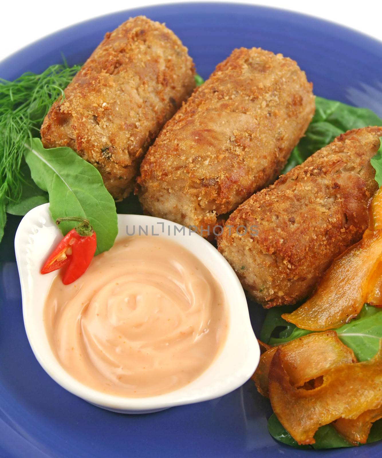 Crumbed tuna croquettes with sweet potatoes and a rocket salad.