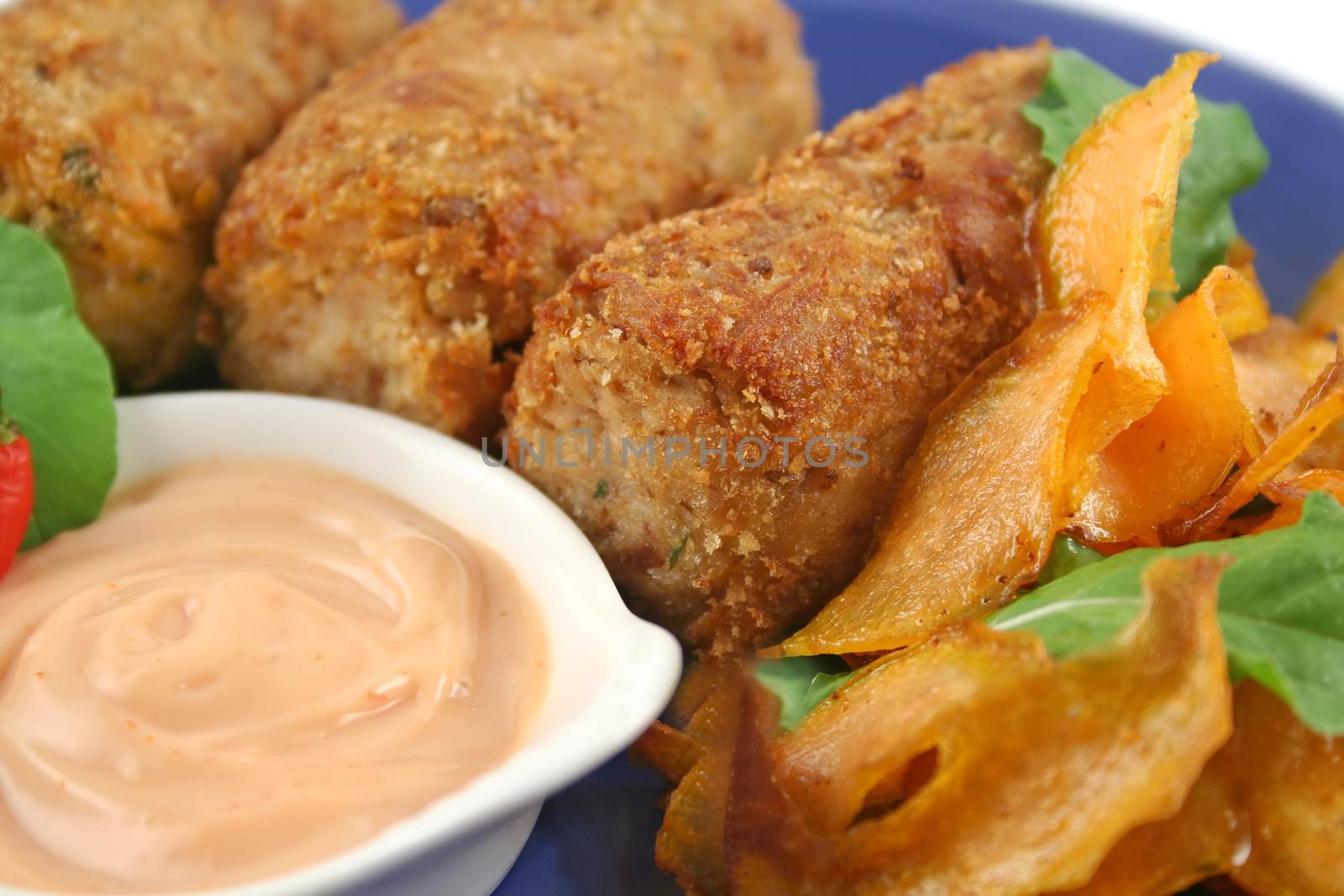 Crumbed tuna croquettes with sweet potatoes and a rocket salad.