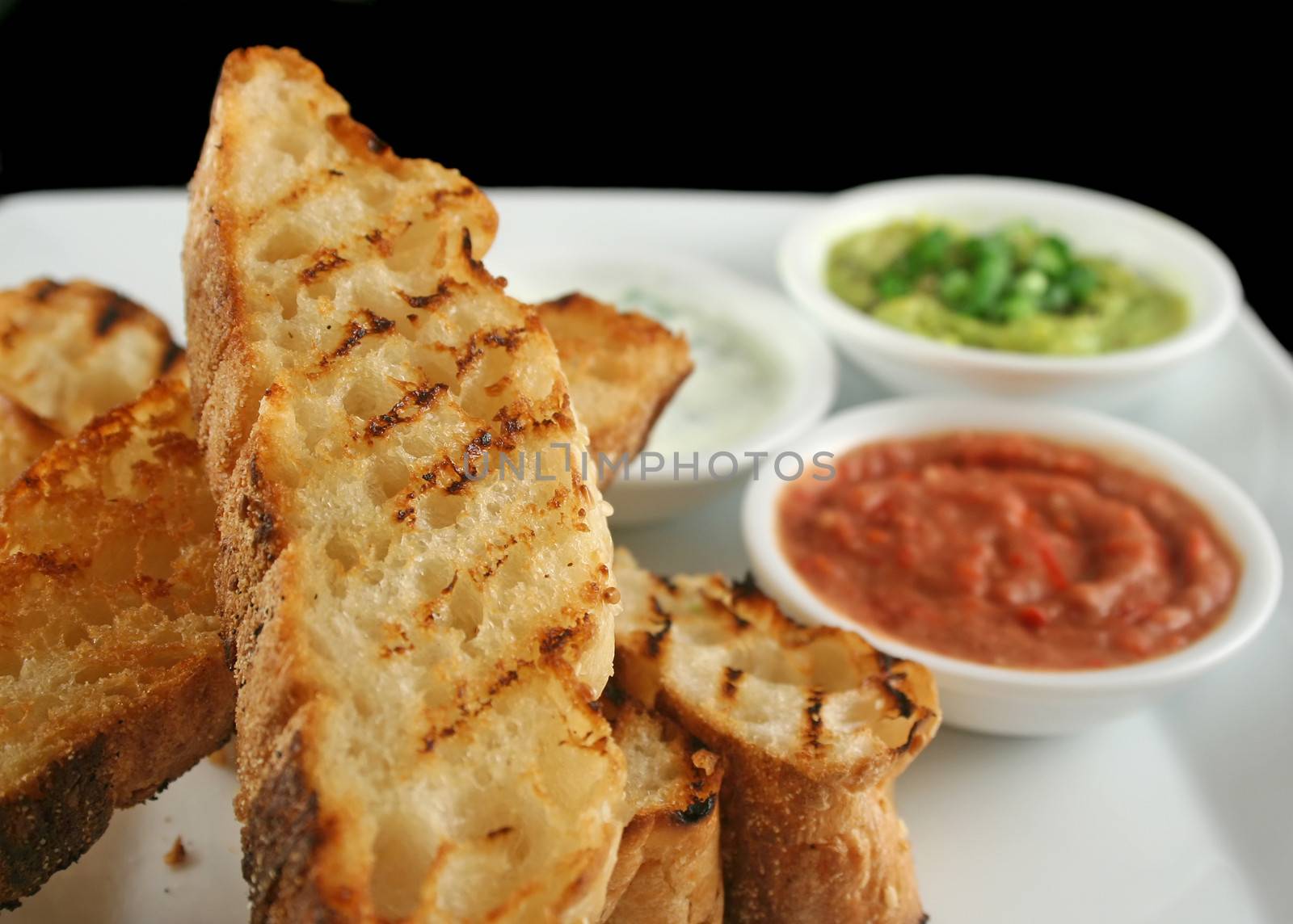 Delicious and colorful trio of dips with grilled Turkish bread.