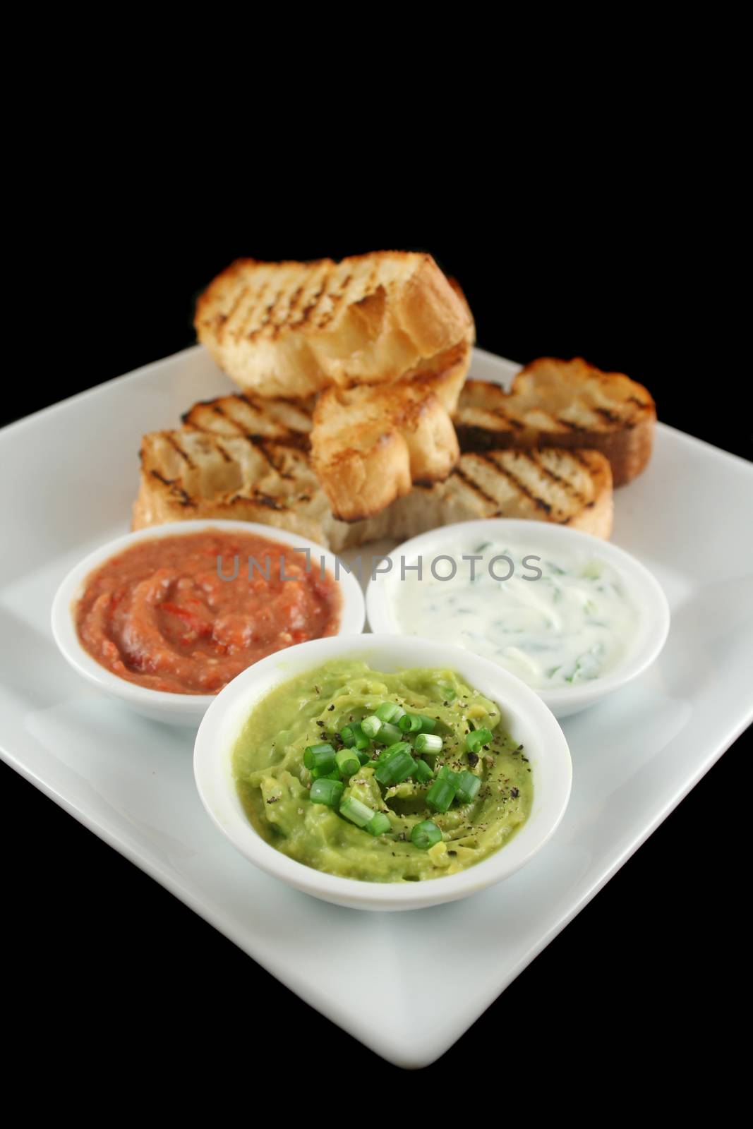 Delicious and colorful trio of dips with grilled Turkish bread.