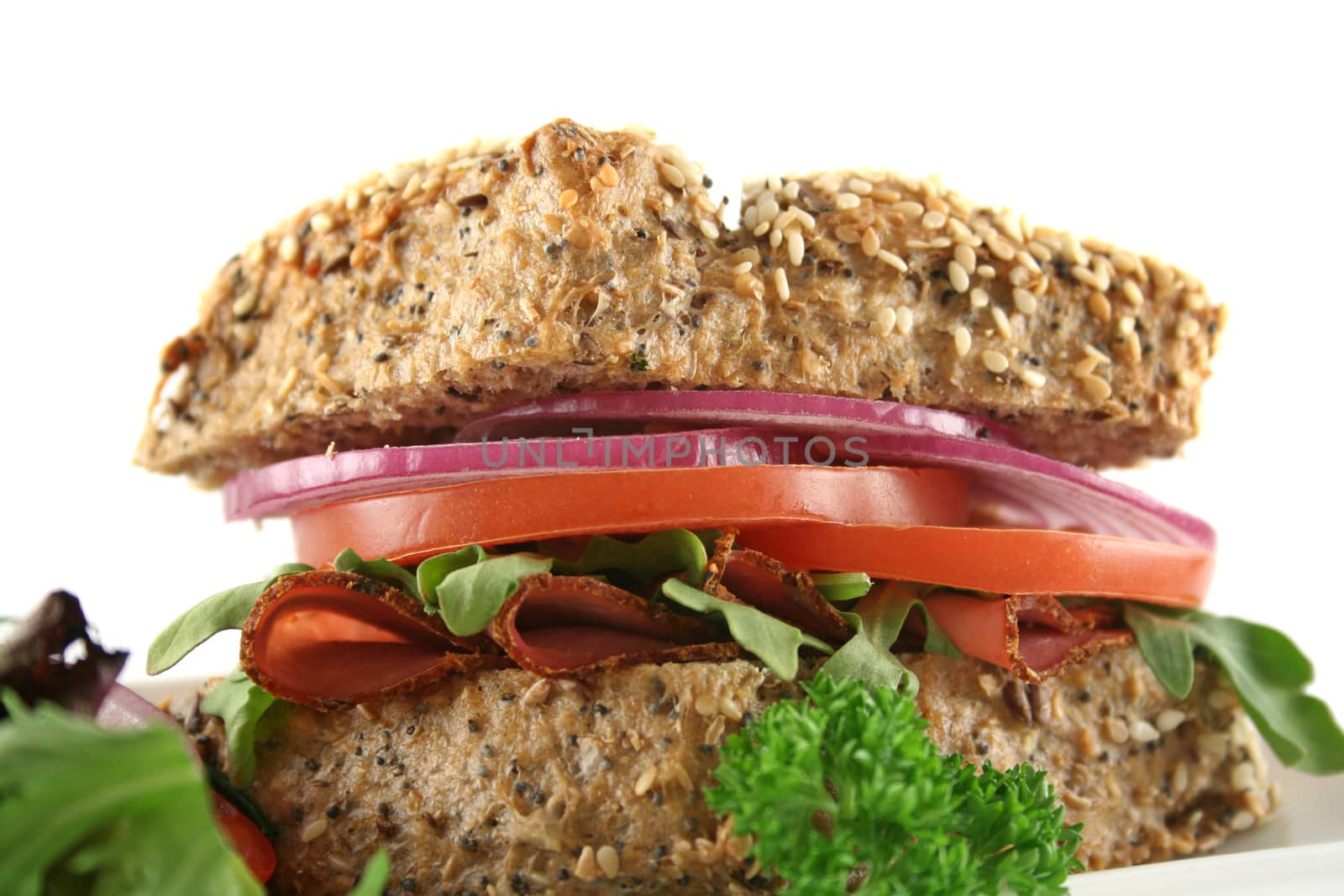 Pastrami and salad wholegrain seeded roll ready to serve.